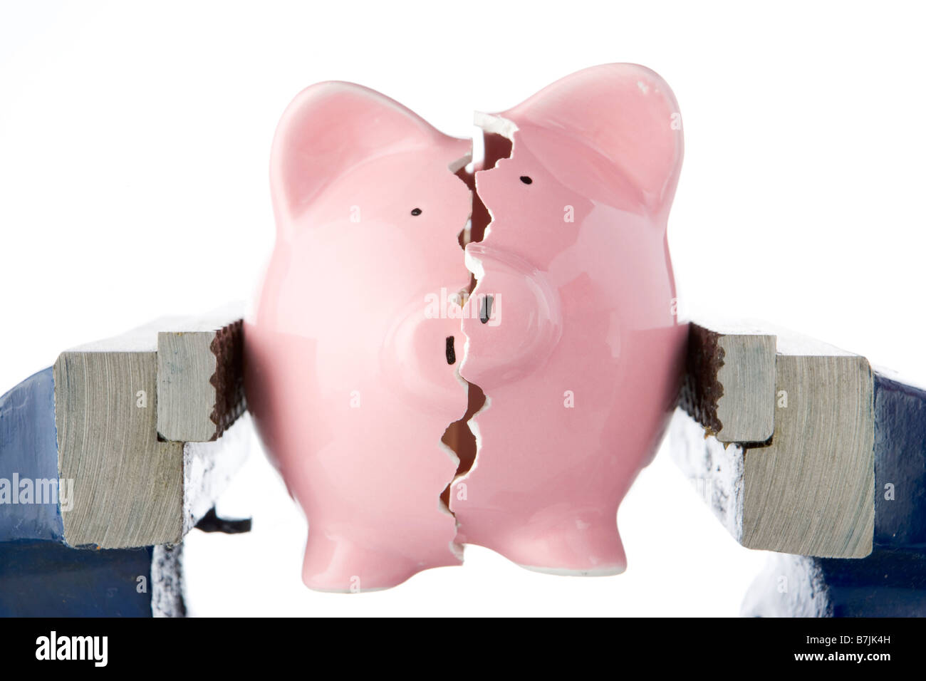 Piggy Bank Split In Two Whilst Being Held In Vice Stock Photo