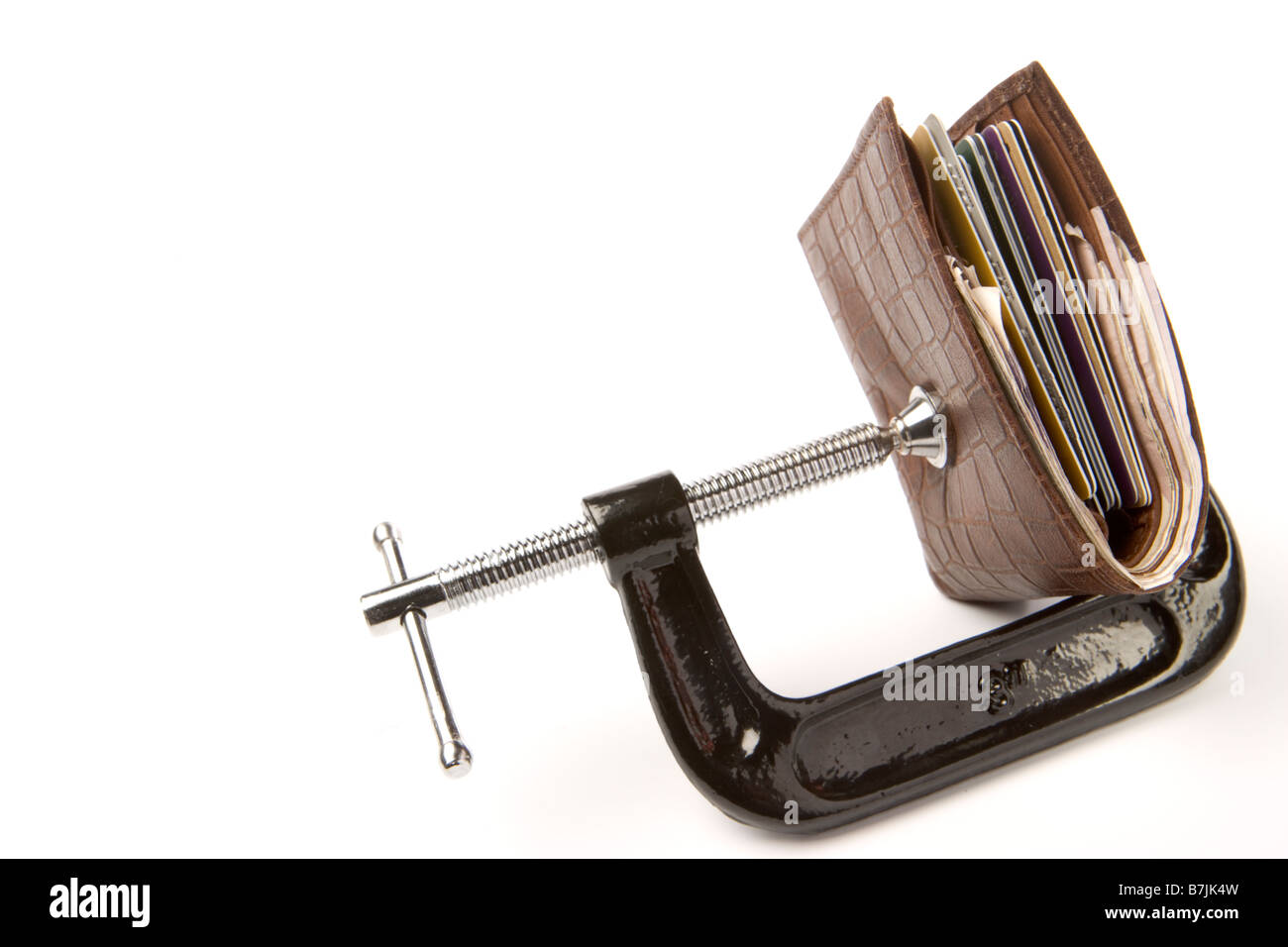 Leather Wallet Being Held In Clamp On White Background Stock Photo