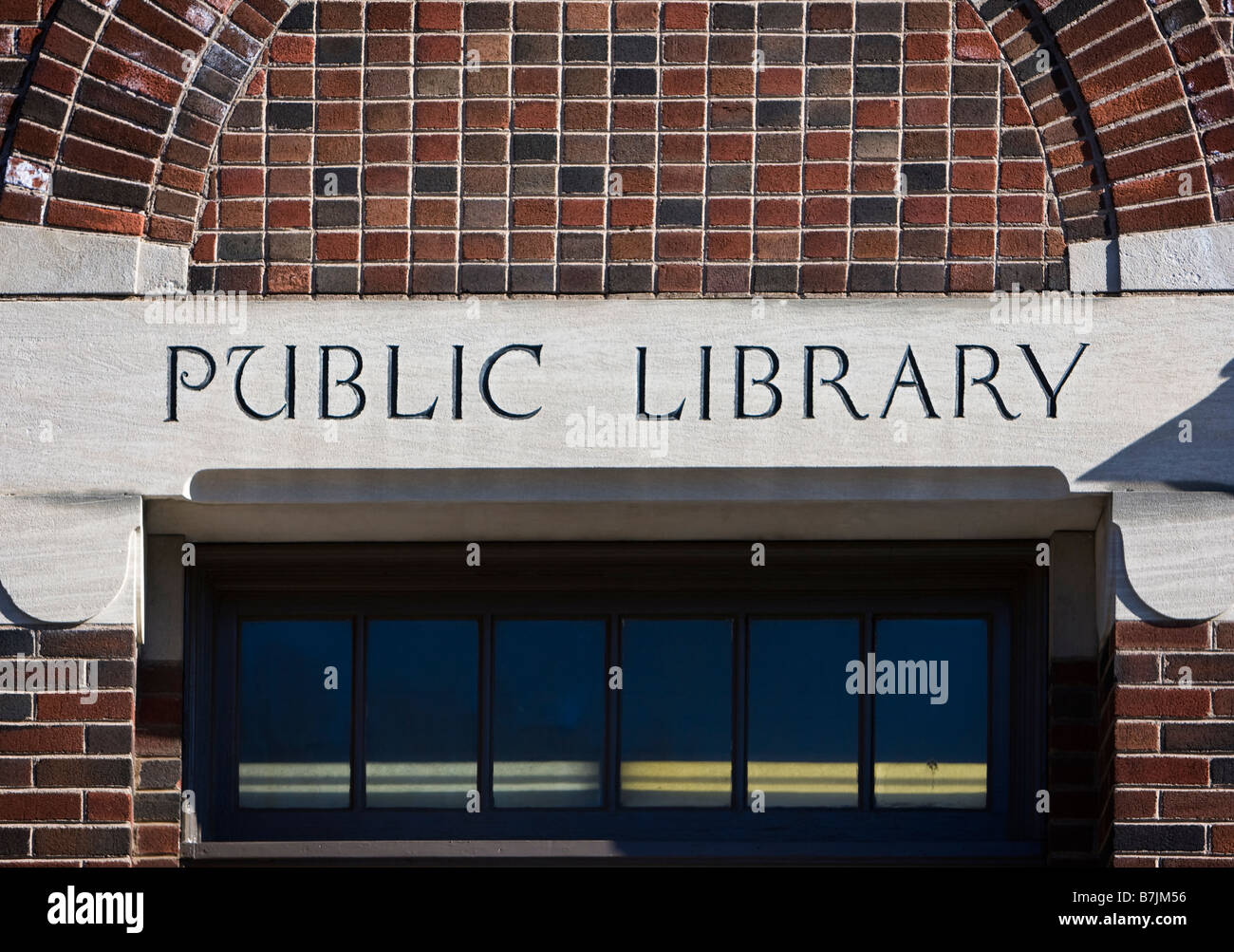 Public library sign in front of a library Stock Photo - Alamy