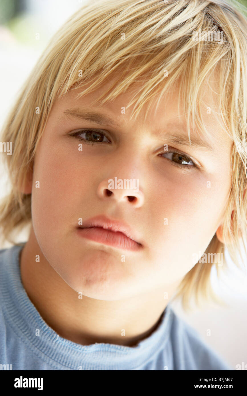 Portrait Of Young Boy Frowning Stock Photo