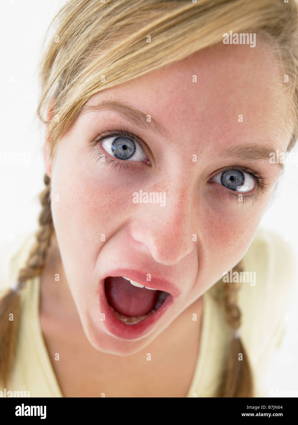 Portrait Of Teenage Girl Looking Shocked Stock Photo