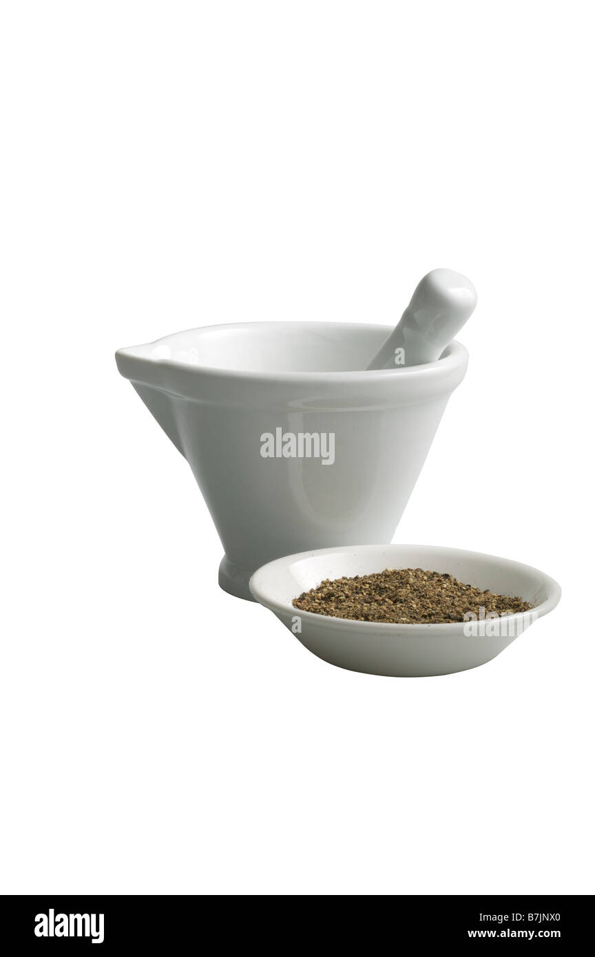 Pestle and Mortar with ground black pepper corn spice in a dish in