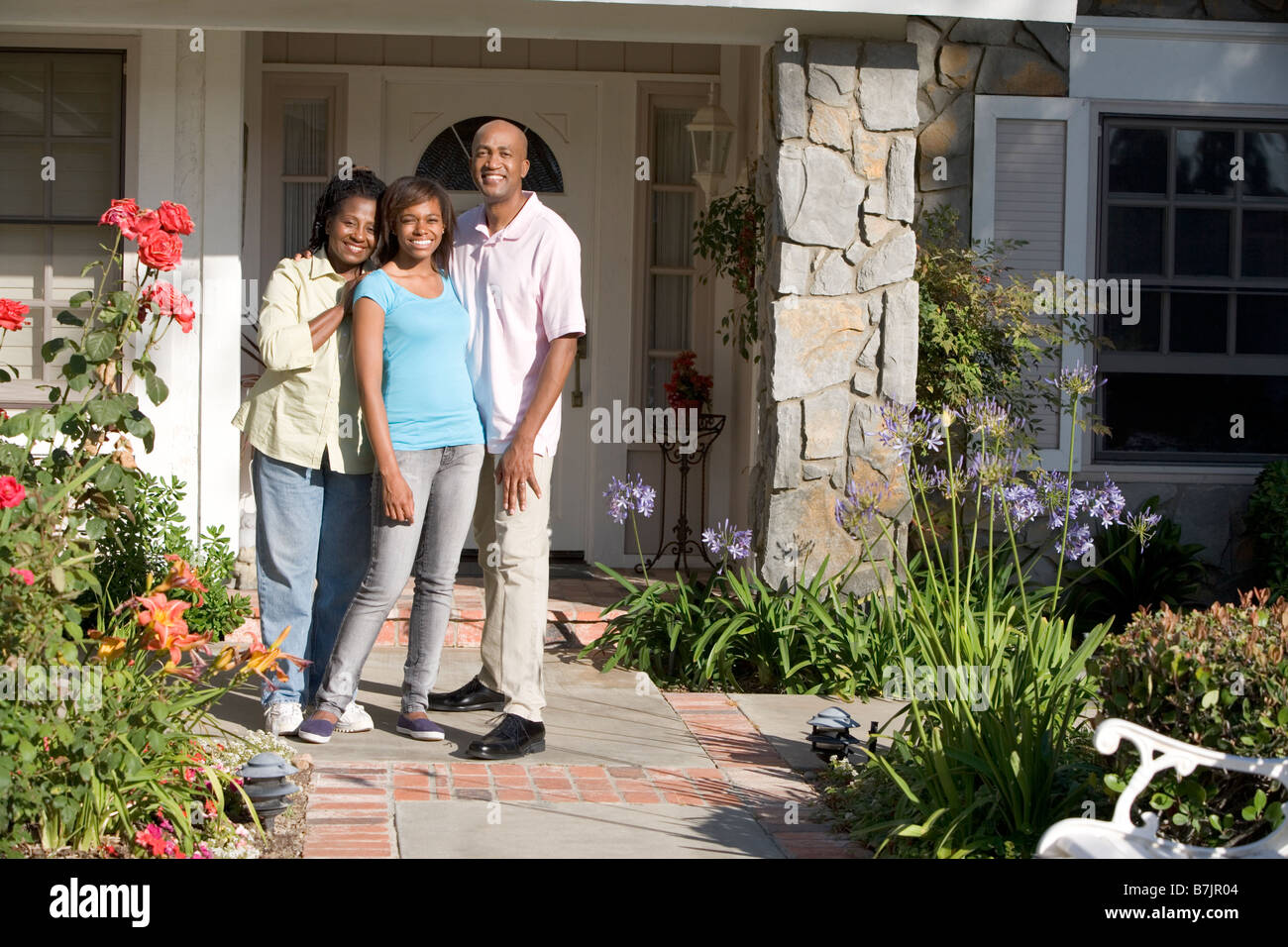 Family Standing Outside House Stock Photo Alamy