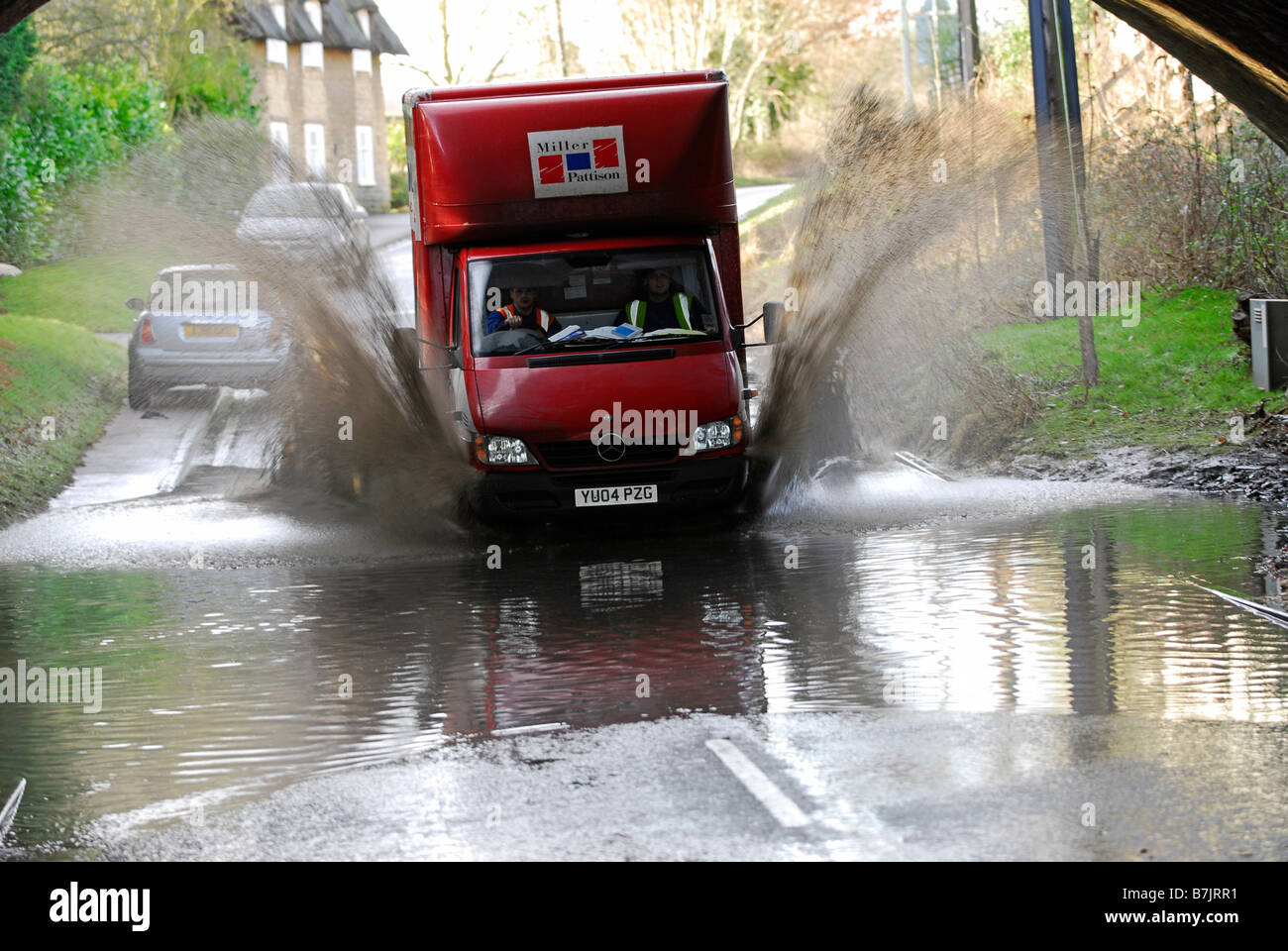 Van drives through flood water in Sharnbrook, Bedfordshire, UK Stock Photo