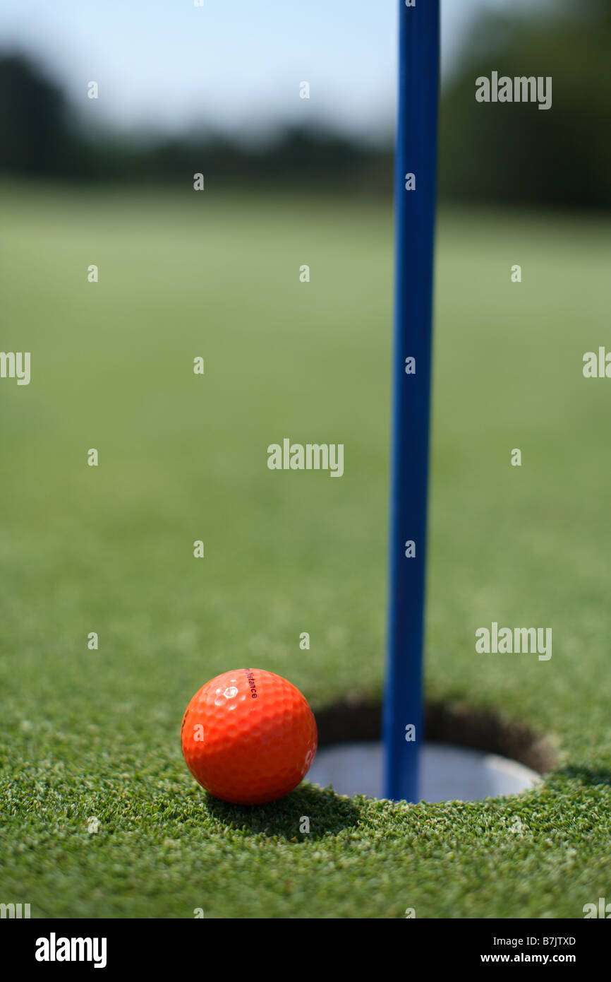 Golf ball near hole Stock Photo Alamy