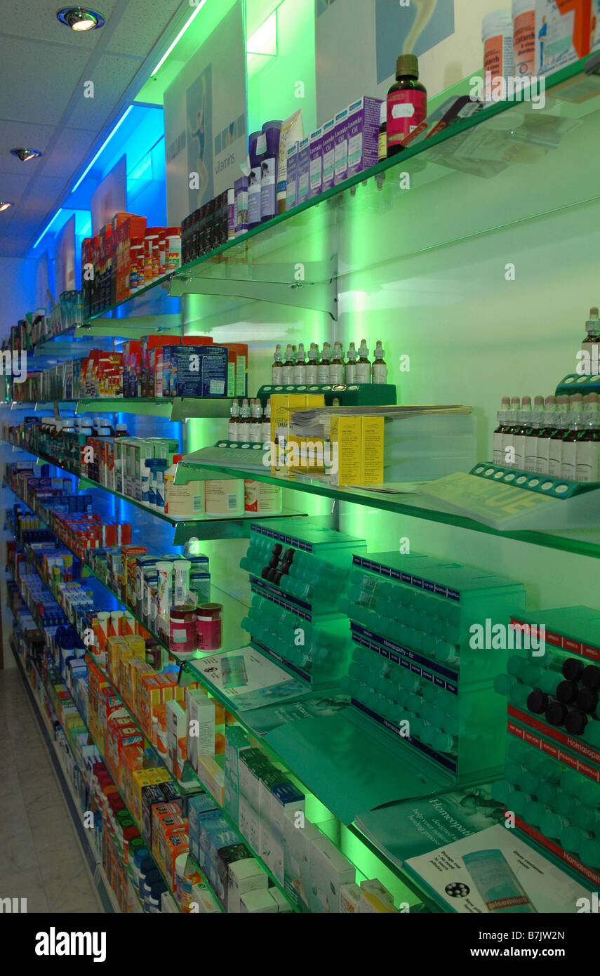 Shelves in a pharmacy or a dispensary full of boxes and packs of medicines and lotions Stock Photo
