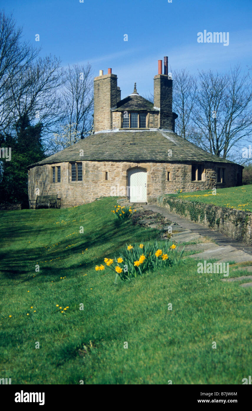 Beamsley Hospital almshouses Round chapel Daffodils BOLTON ABBEY NORTH YORKSHIRE ENGLAND Stock Photo