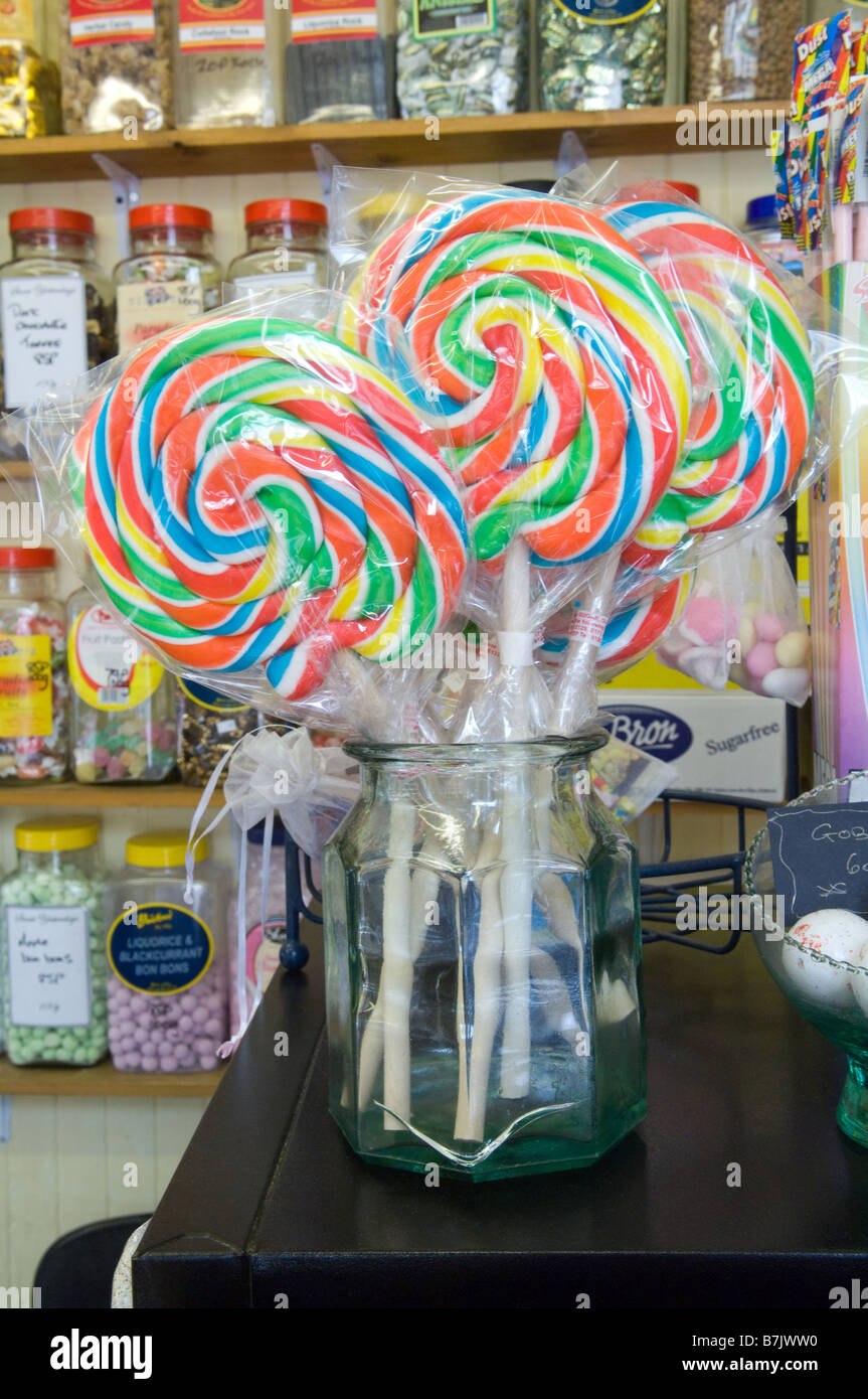 A jar of giant lollipops for sale in an old fashioned sweetie and candy shop. Stock Photo