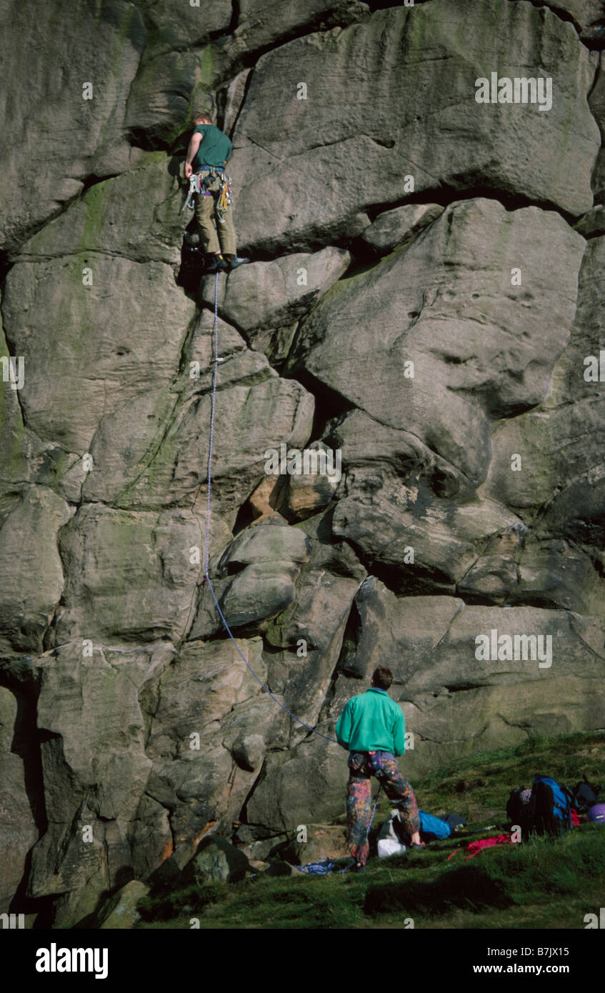 Two men rock climbing at almscliffe crag hires stock photography and