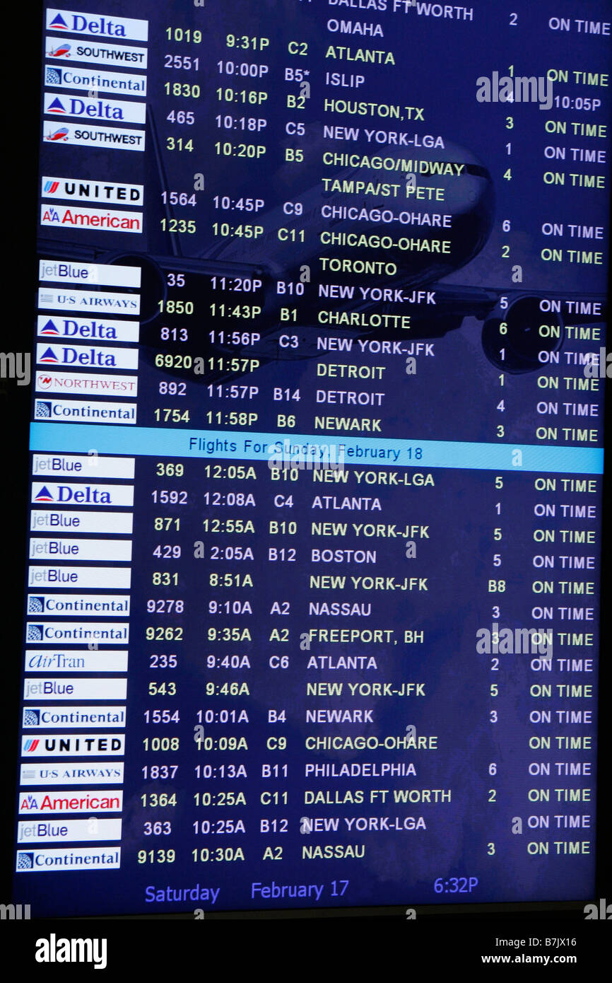 Airport Arrivals Board electronic screen monitor displays domestic flights of airlines all arriving on time. Stock Photo