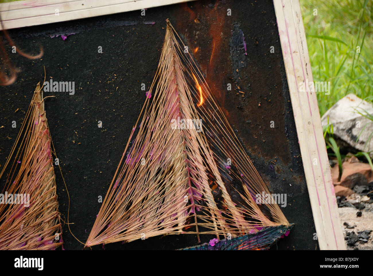 burning sail boat string art on fire outside Stock Photo