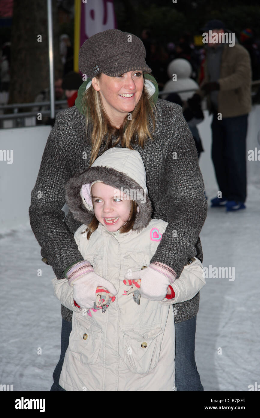 smile smiling female mother daughter young girl ice skating skaters rink open air winter wonderland hyde park london england Stock Photo