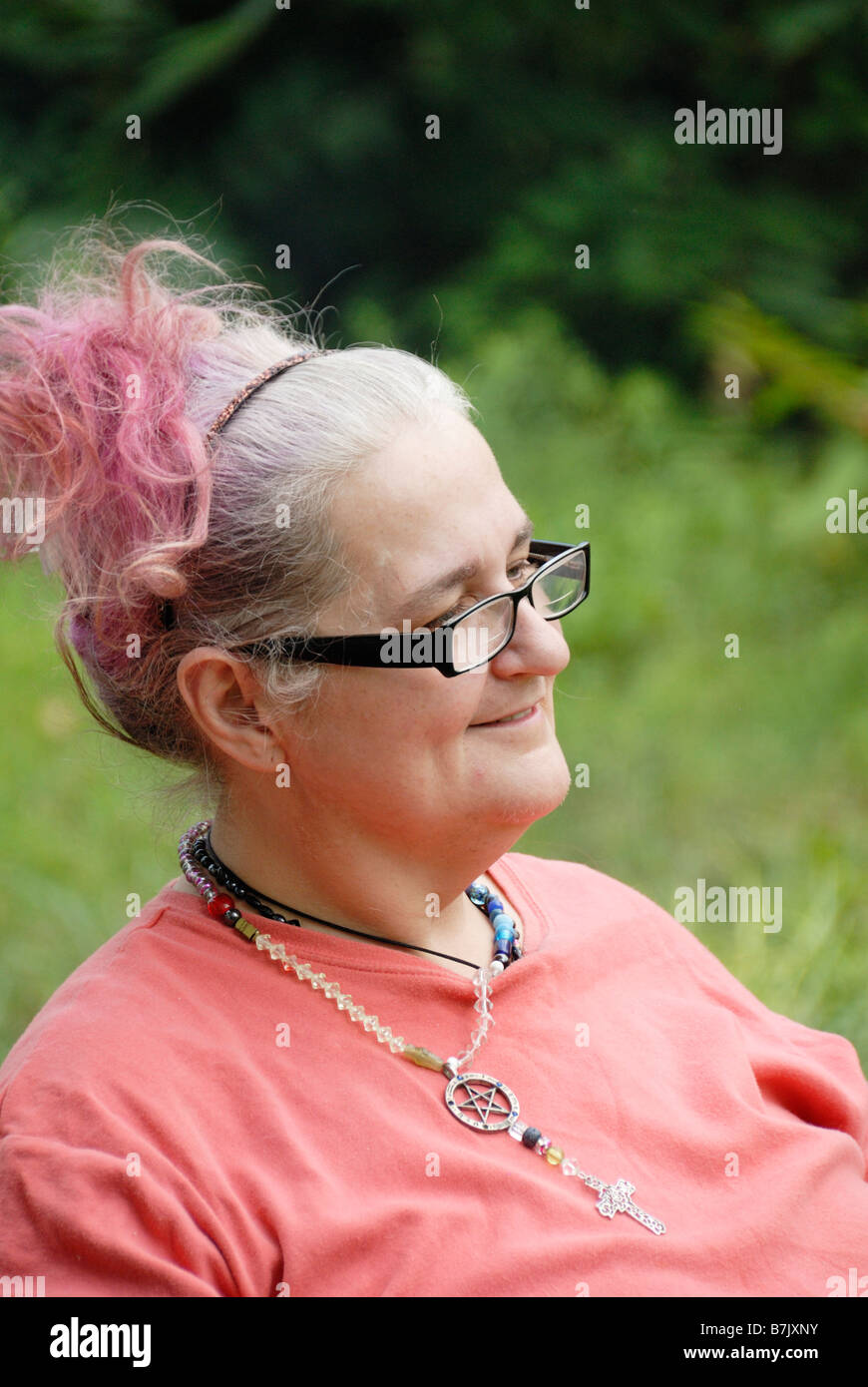 Elderly woman with grey and purple hair and black glasses Stock Photo ...