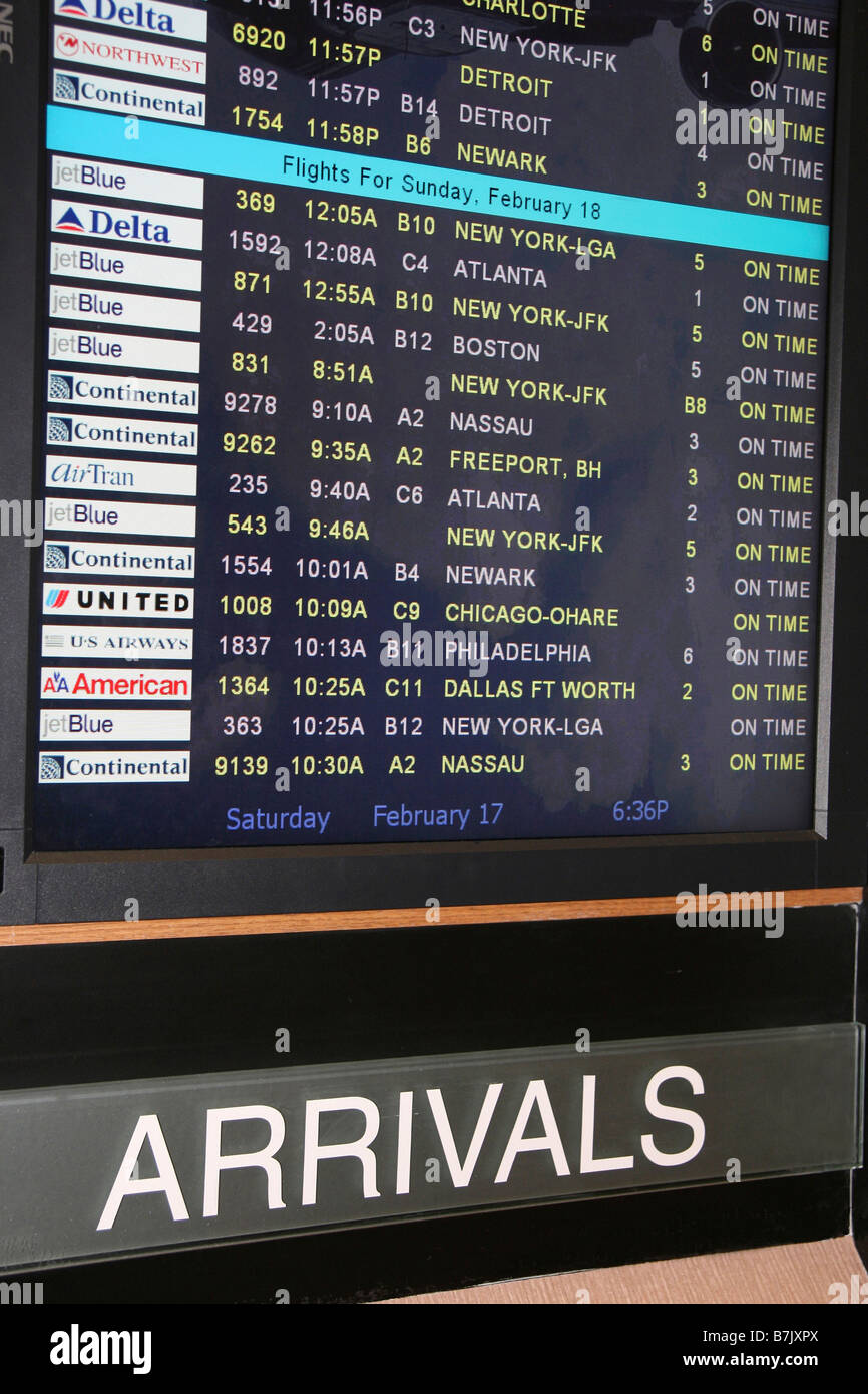 Airport Arrivals screen displays domestic flights of airlines all arriving on time. Stock Photo