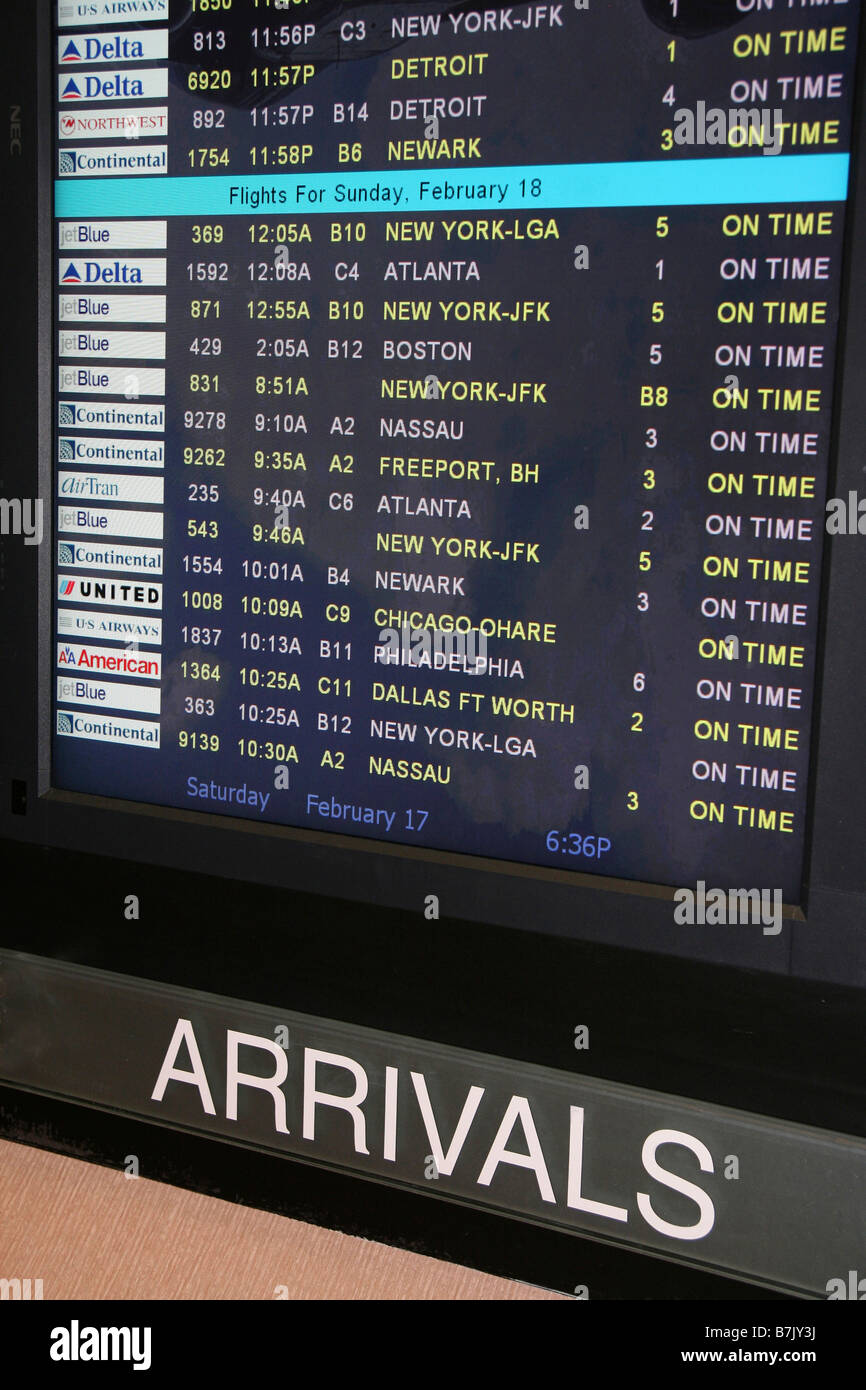 Airport Arrivals screen displays domestic flights of airlines all arriving on time. Stock Photo