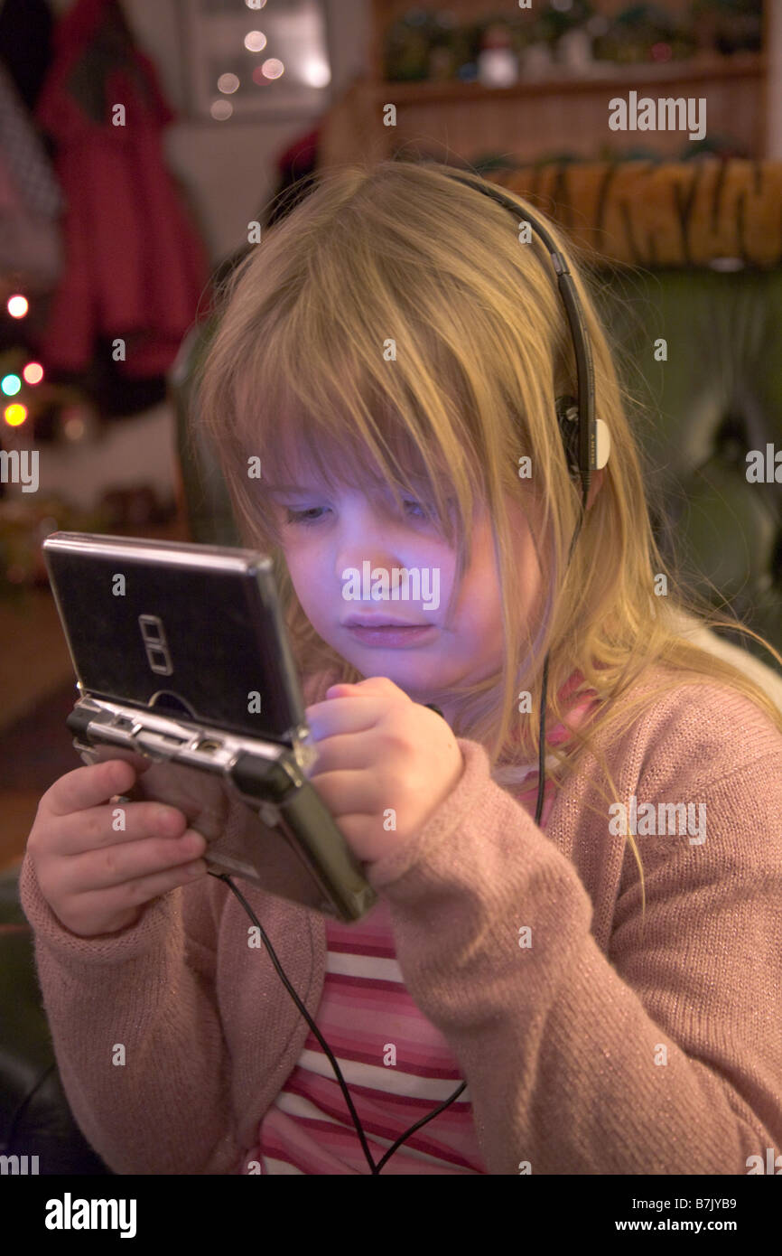 5 year old girl playing Nintendo ds Lite console Stock Photo