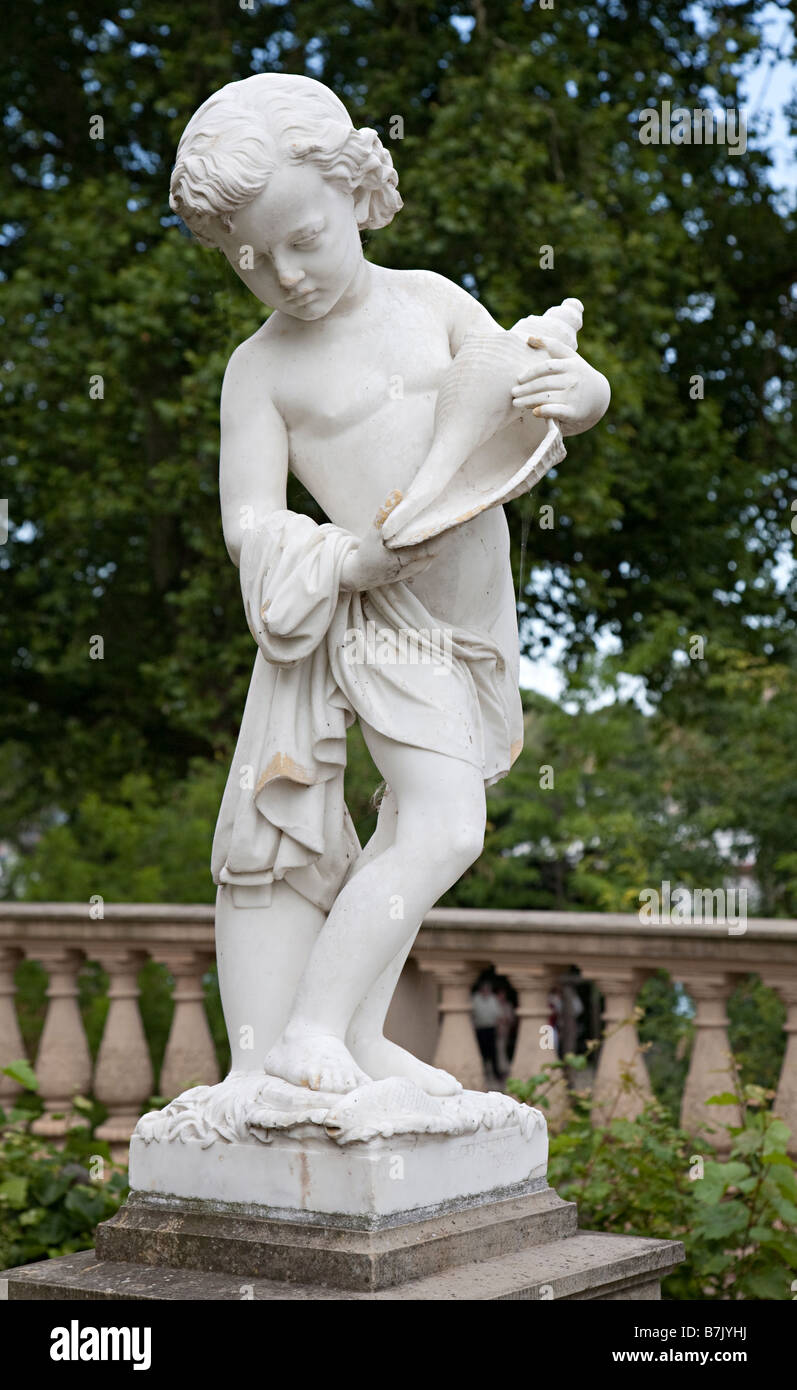 Statue in marble of child holding seashell titled The Allegory of Water in grounds of castle Schwerin Germany Stock Photo
