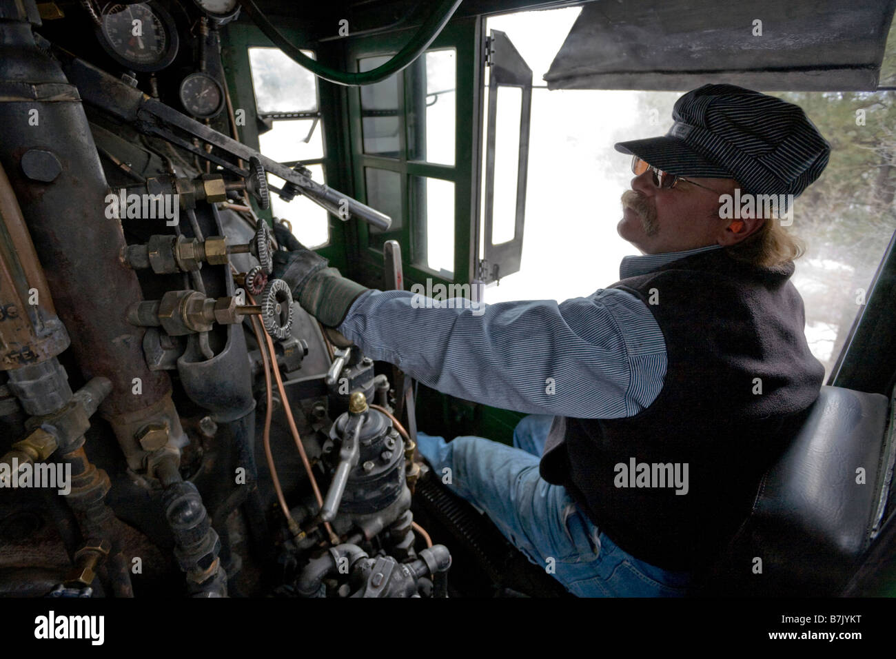 Engineer operates a steam powered locomotive on the Durango Silverton Narrow Gauge Railroad, southwestern Colorado Stock Photo