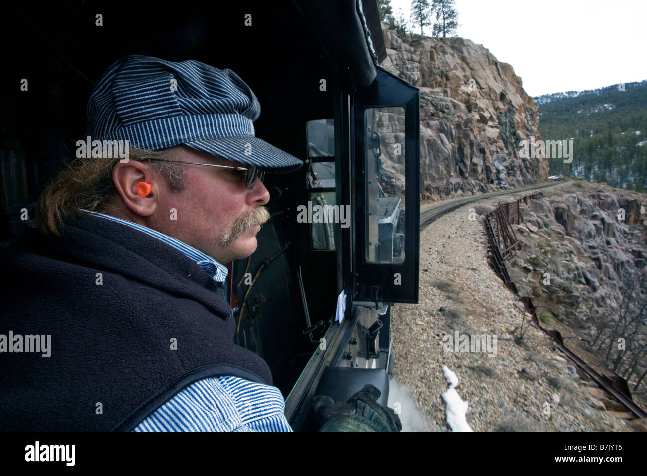 Engineer in a steam powered locomotive on the Durango Silverton Narrow Gauge Railroad, southwestern Colorado Stock Photo