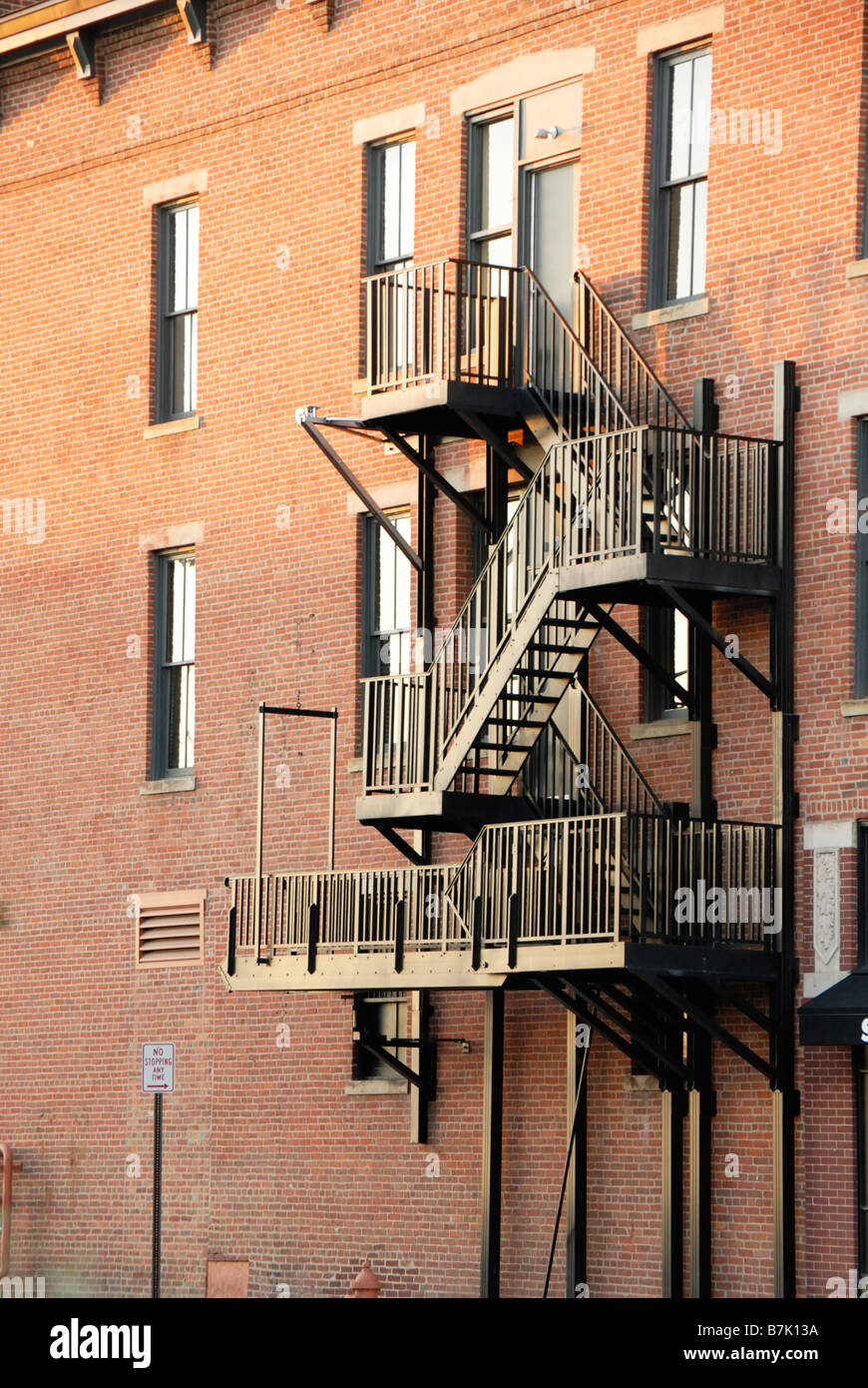 Fire escape on side of red brick building Stock Photo