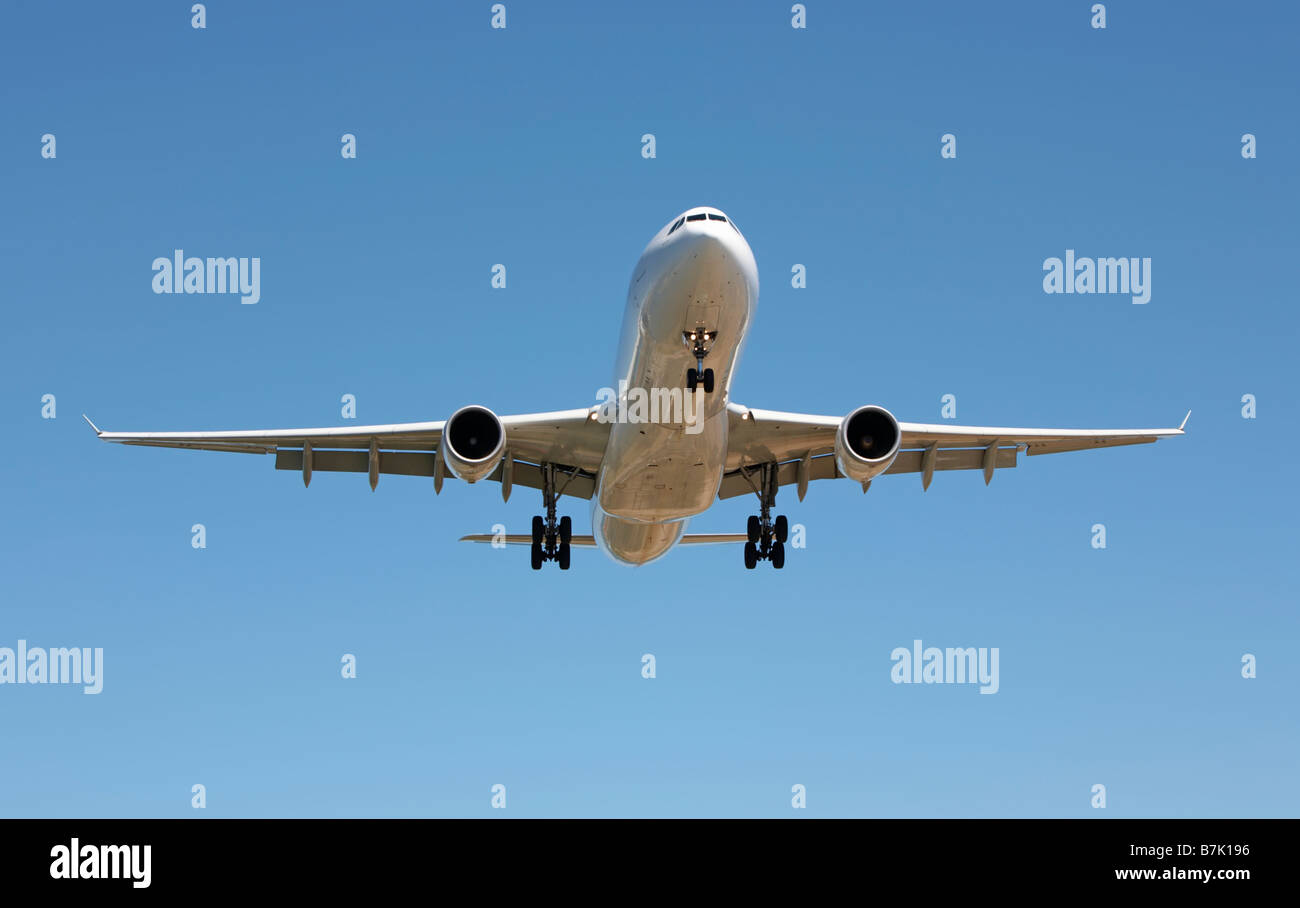 Twin engined jet aircraft coming in to land Stock Photo