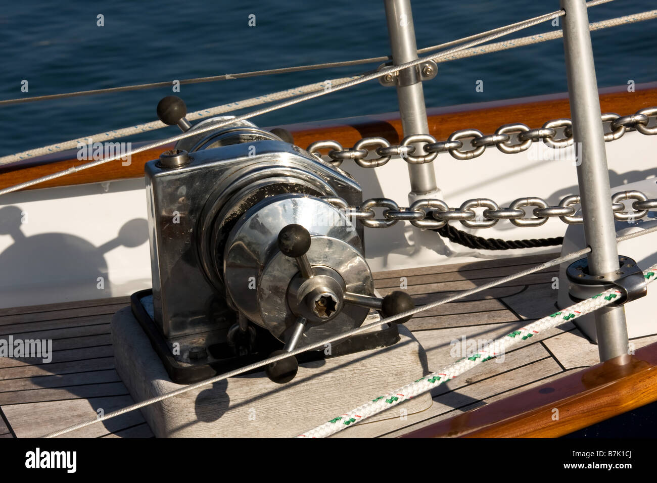stainless steel anchor windlass on bow of sailing yacht Stock