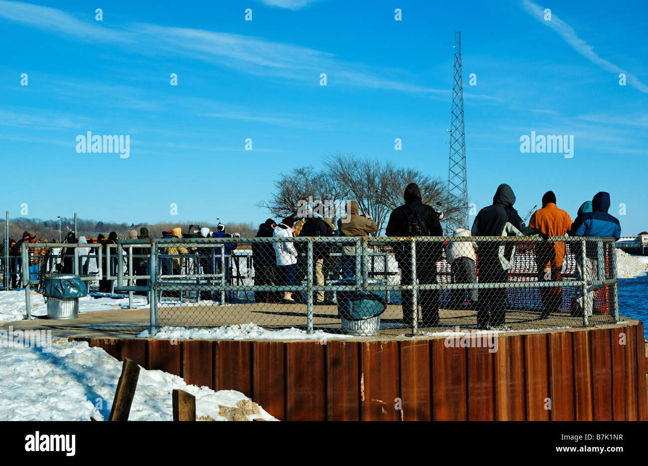 Photographers stand on one of the walkways overlooking the Mississippi river at Lock and Dam 14. Stock Photo