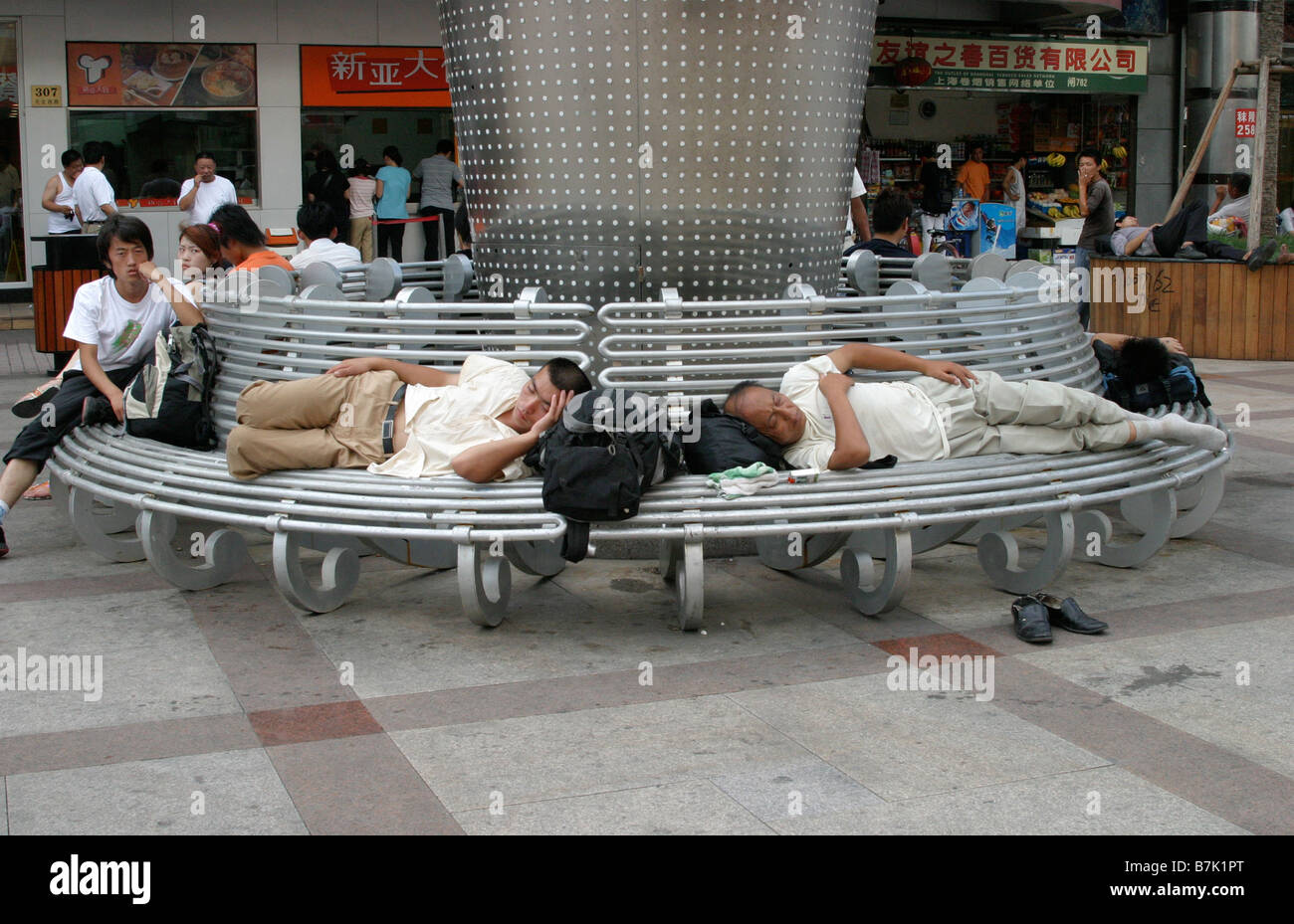 Sleeping Chinese on a street of Shanghai. People take a nap anywhere