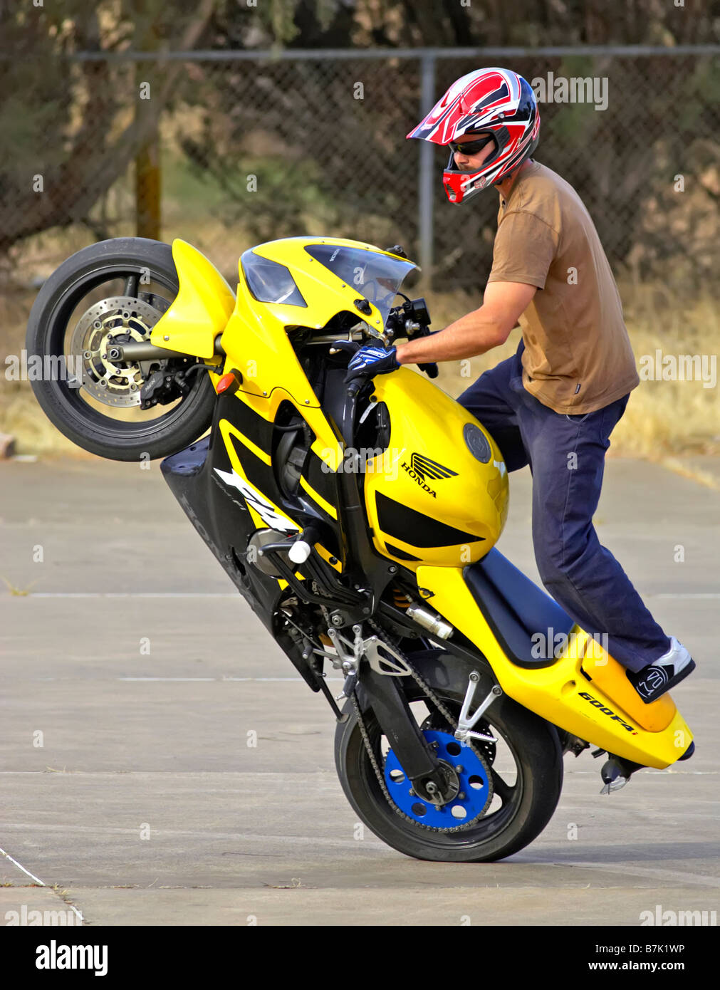 stunt rider mono wheelie motor bike action cycle upright Stock Photo