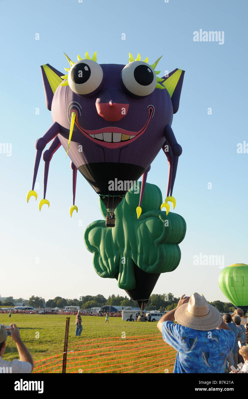 Hot air balloons in the shape of a crab and clover leaf at the
