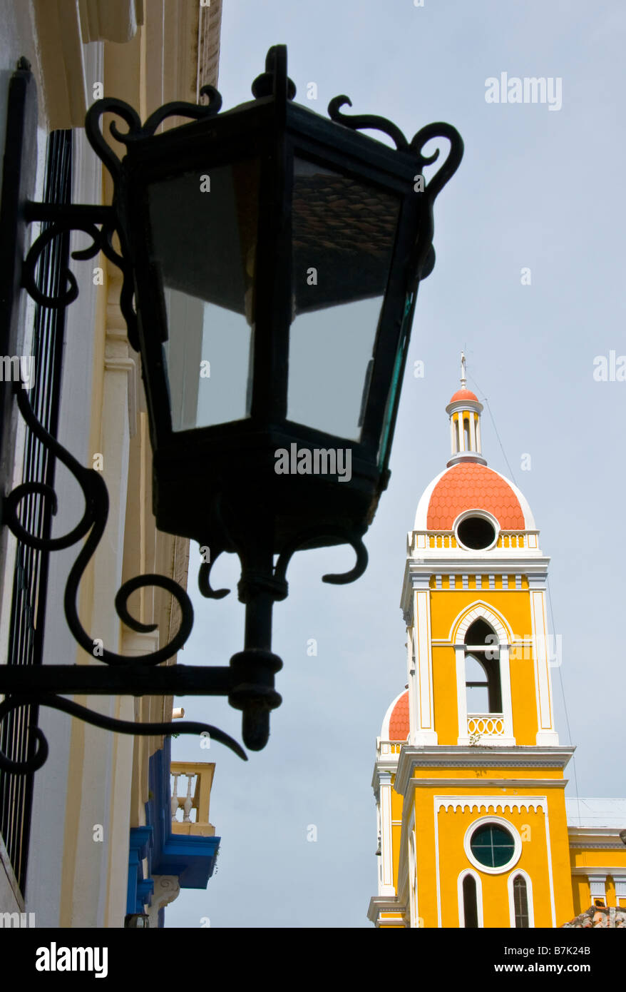 Colonial Granada architecture, the Cathedral bell tower and Hotel La Gran Francia lamp Stock Photo
