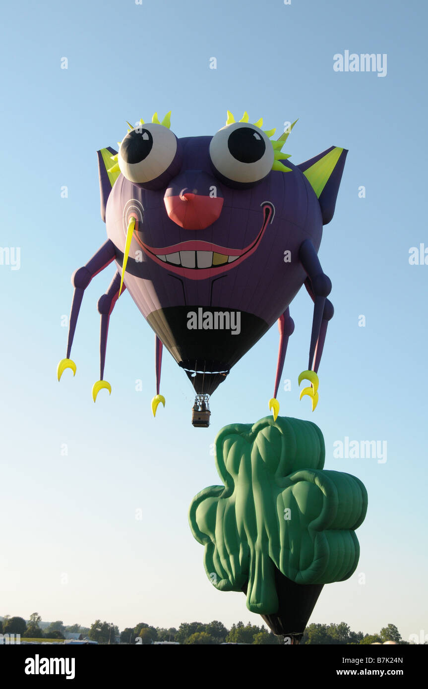 Hot air balloons in the shape of a crab and clover leaf at the