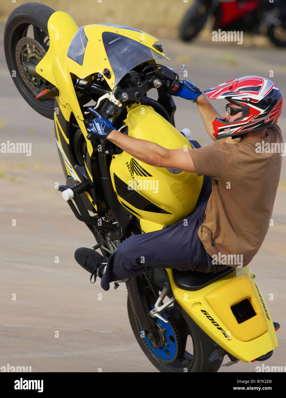 stunt rider mono wheelie motor bike action cycle upright Stock Photo