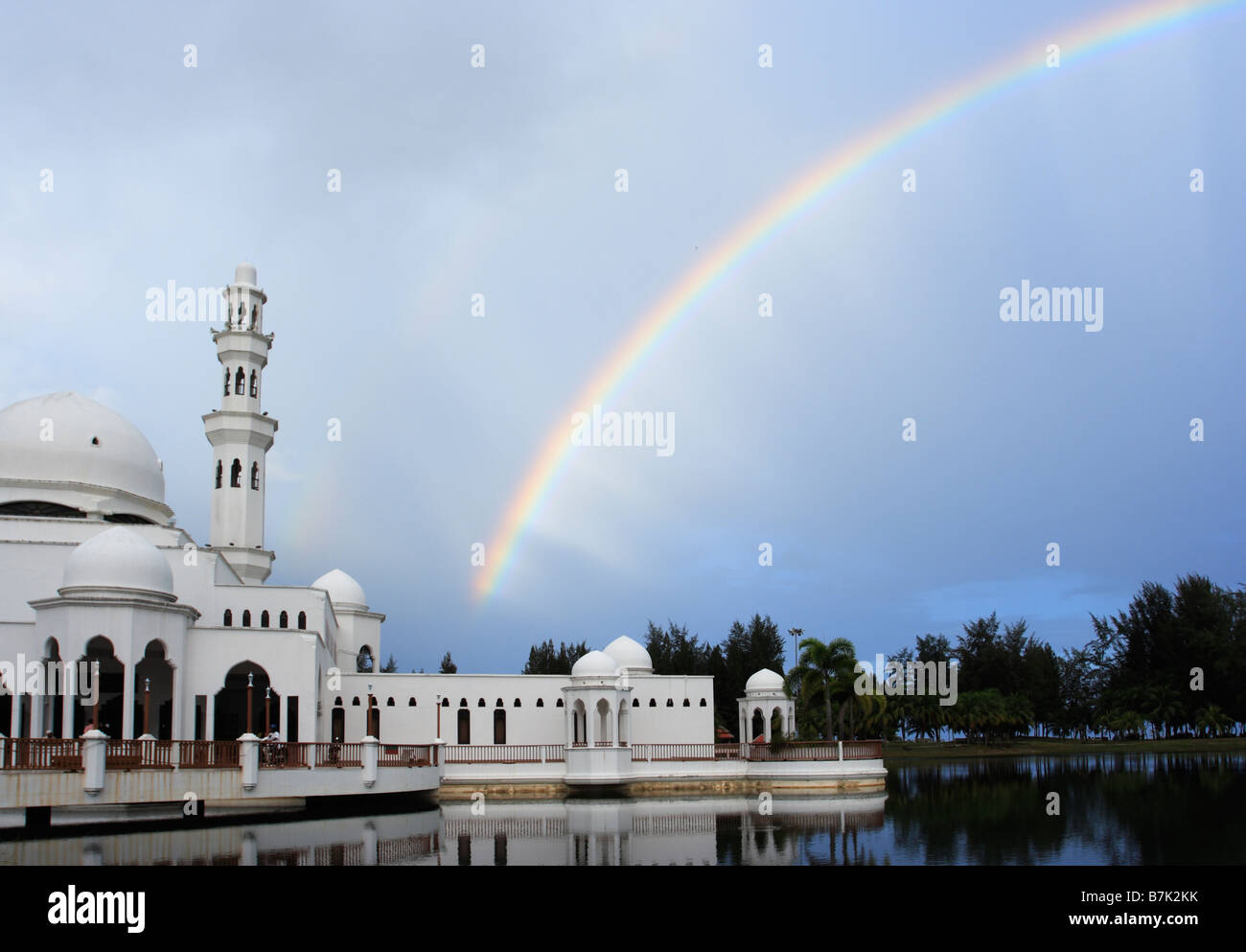 Rainbow and Tengku Tengah Zaharah Mosque also popularly known as the Floating Mosque in  Kuala Terengganu, Malaysia. Stock Photo