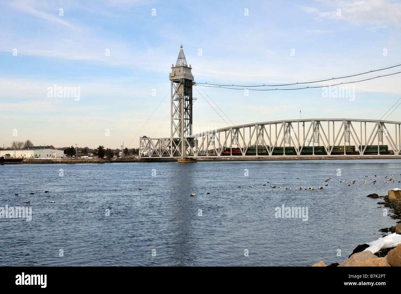 Train engine with cars crossing the Cape Cod Canal on the railroad bridge which raises and lowers for passage across the water Stock Photo