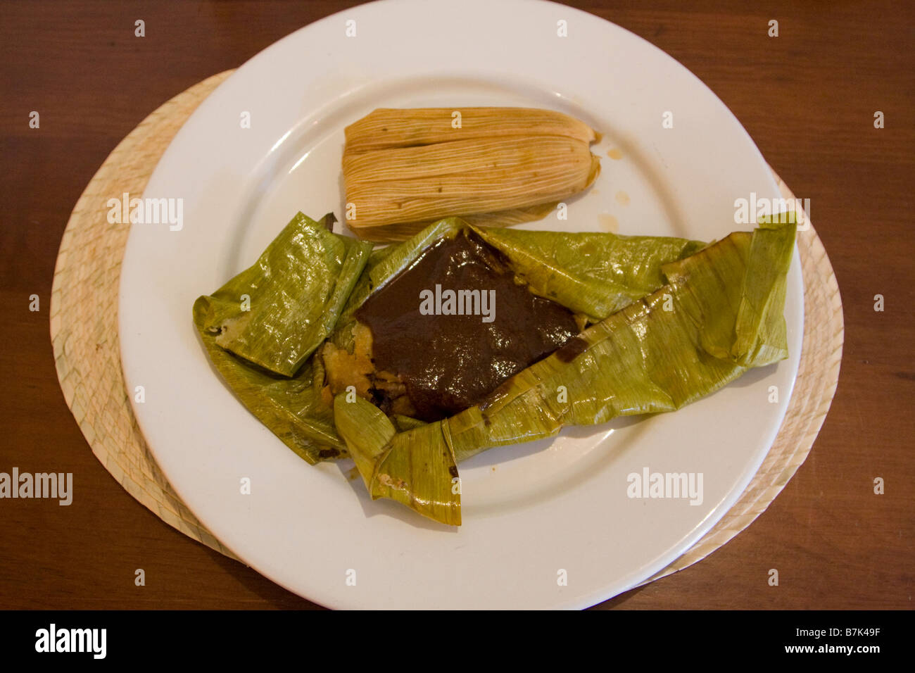 Oaxaca, Mexico. Two Tamales, one in Banana Leaf with Chocolate Mole