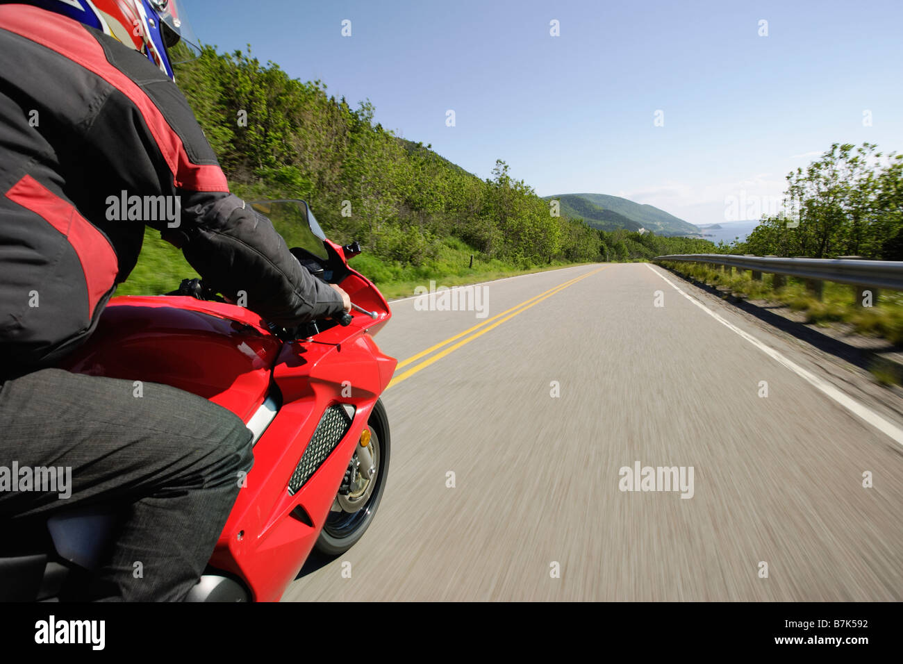 View on Motorcycle in action on Cabot Trail, Cape Breton Highlands National Park, Nova Scotia, Canada Stock Photo