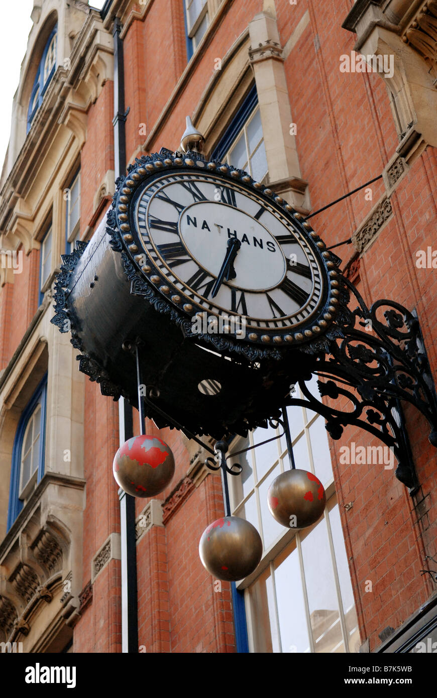Old clock and pawn shop symbol in Corporation Street Birmingham England Stock Photo