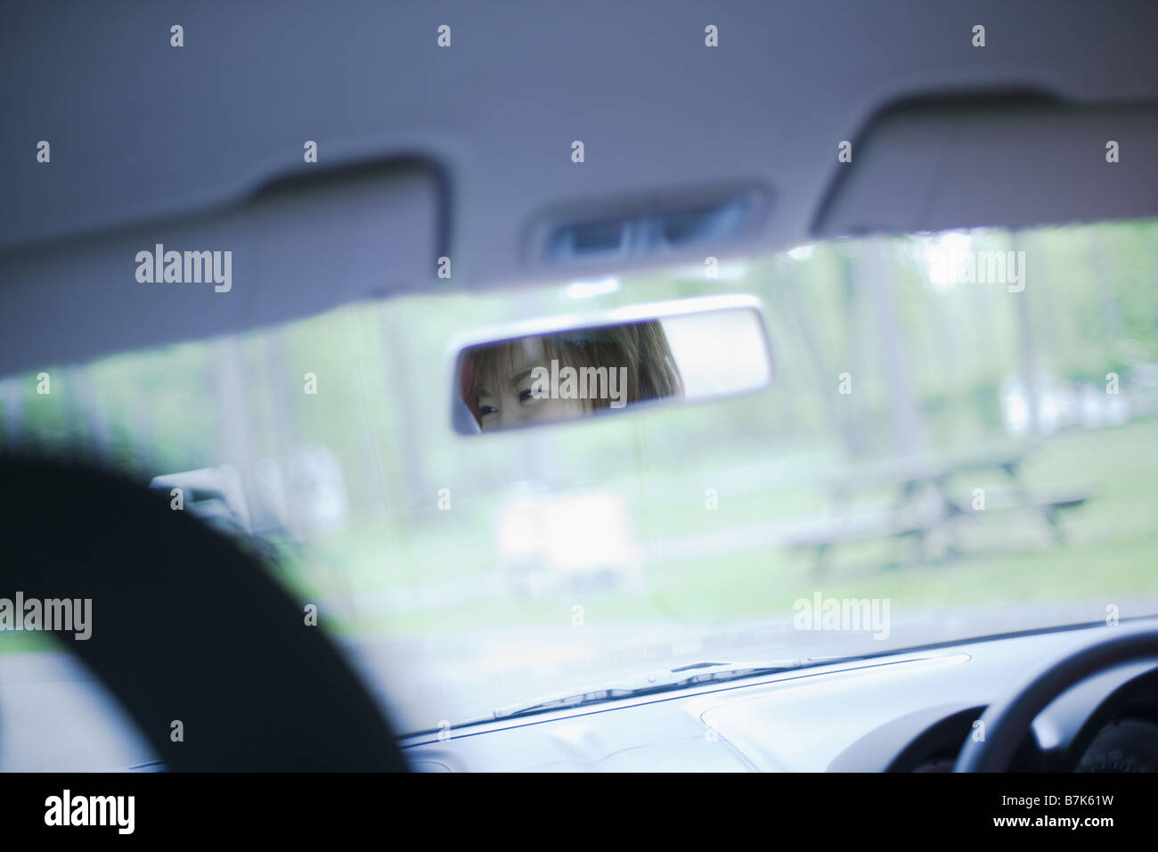 Woman's Face Reflected in a rearview Mirror Stock Photo Alamy