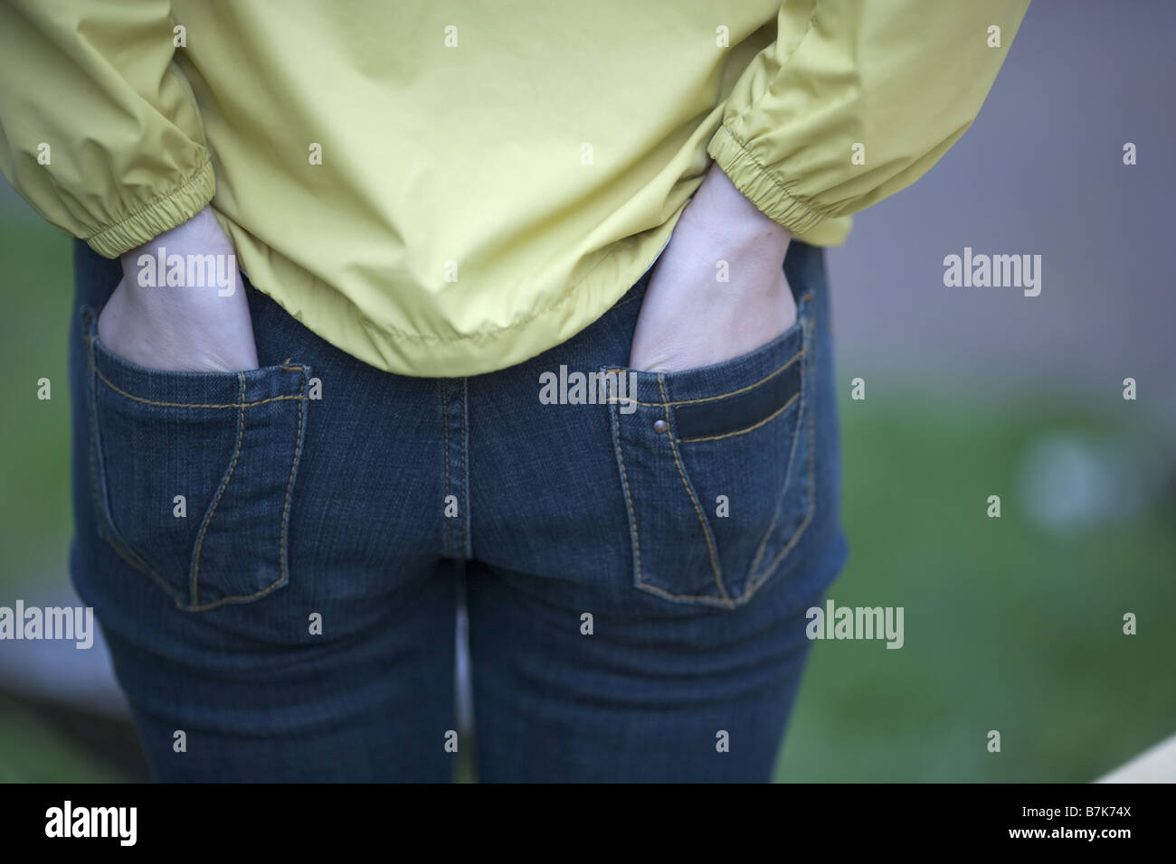 Woman Standing and Put her Hands in Pocket, rear view Stock Photo - Alamy