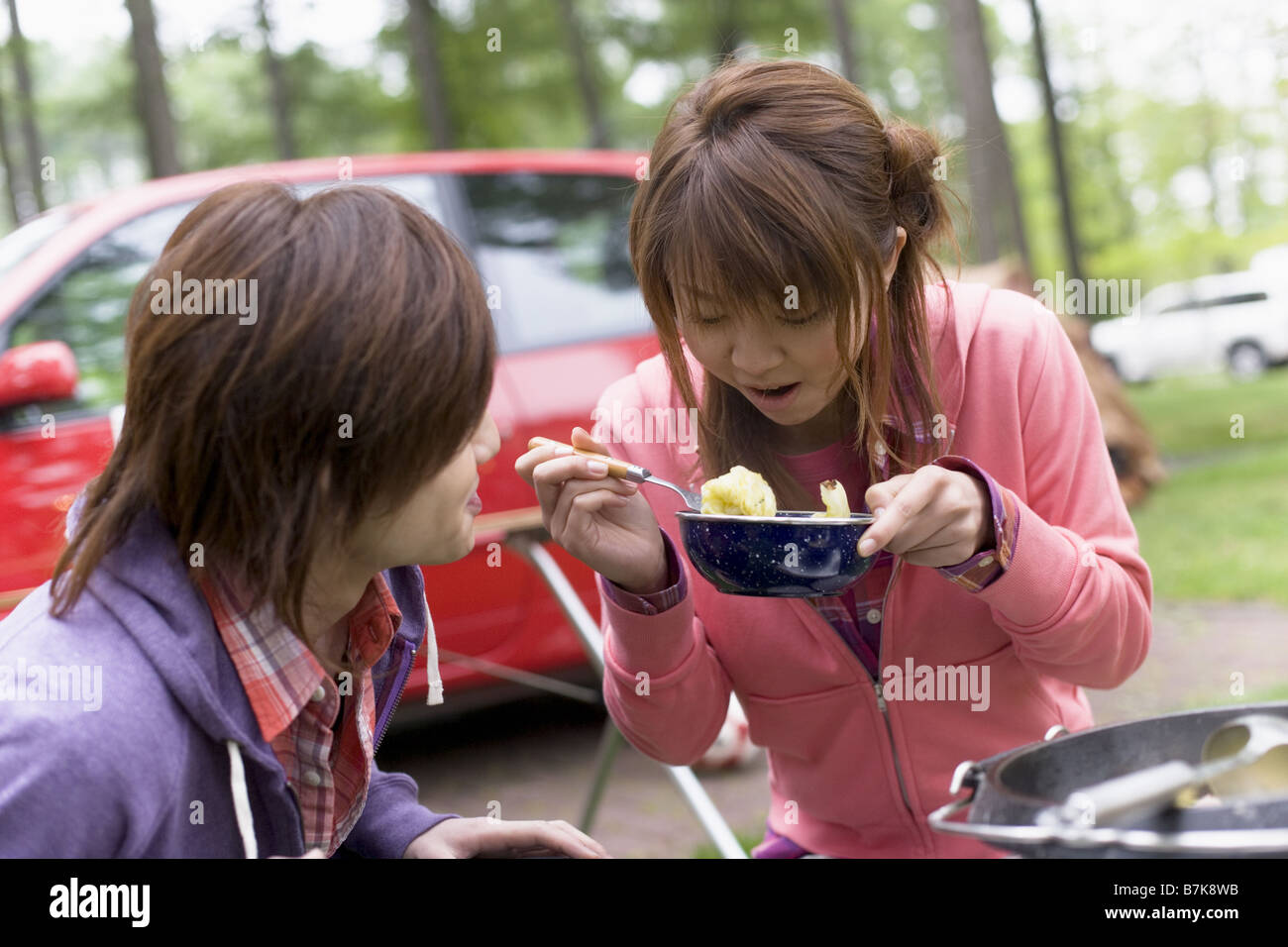 Young Couple Enjoying Meal on Camping Vacation Stock Photo