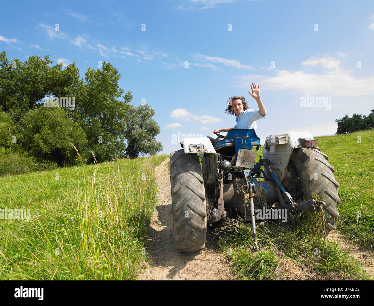 Man driving tractor in field Stock Photo Alamy