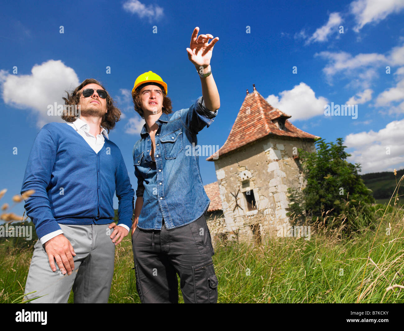 Man with contractor in front of house Stock Photo