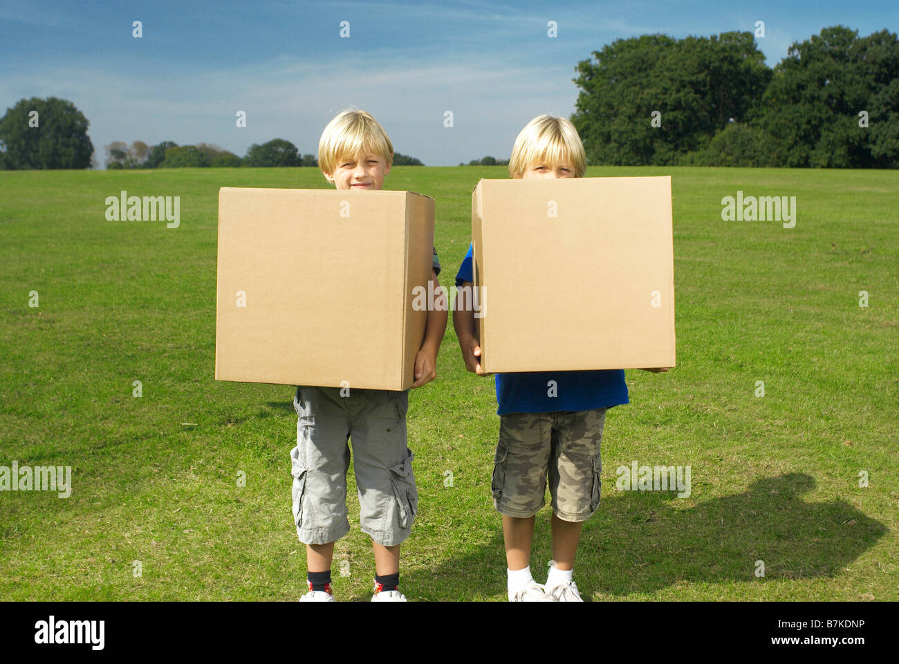 two boys holding boxes Stock Photo - Alamy