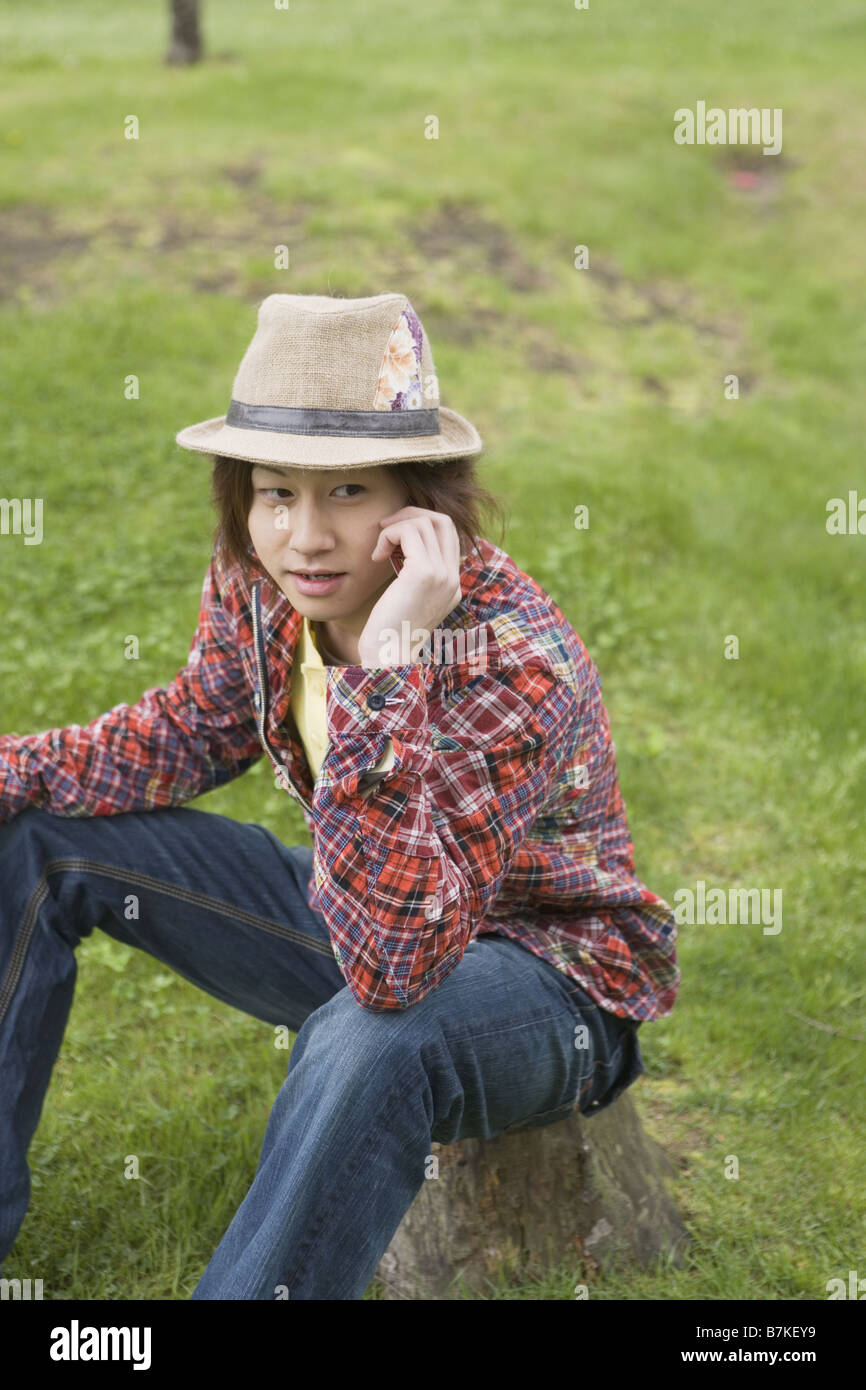 Young man sitting hi-res stock photography and images - Alamy