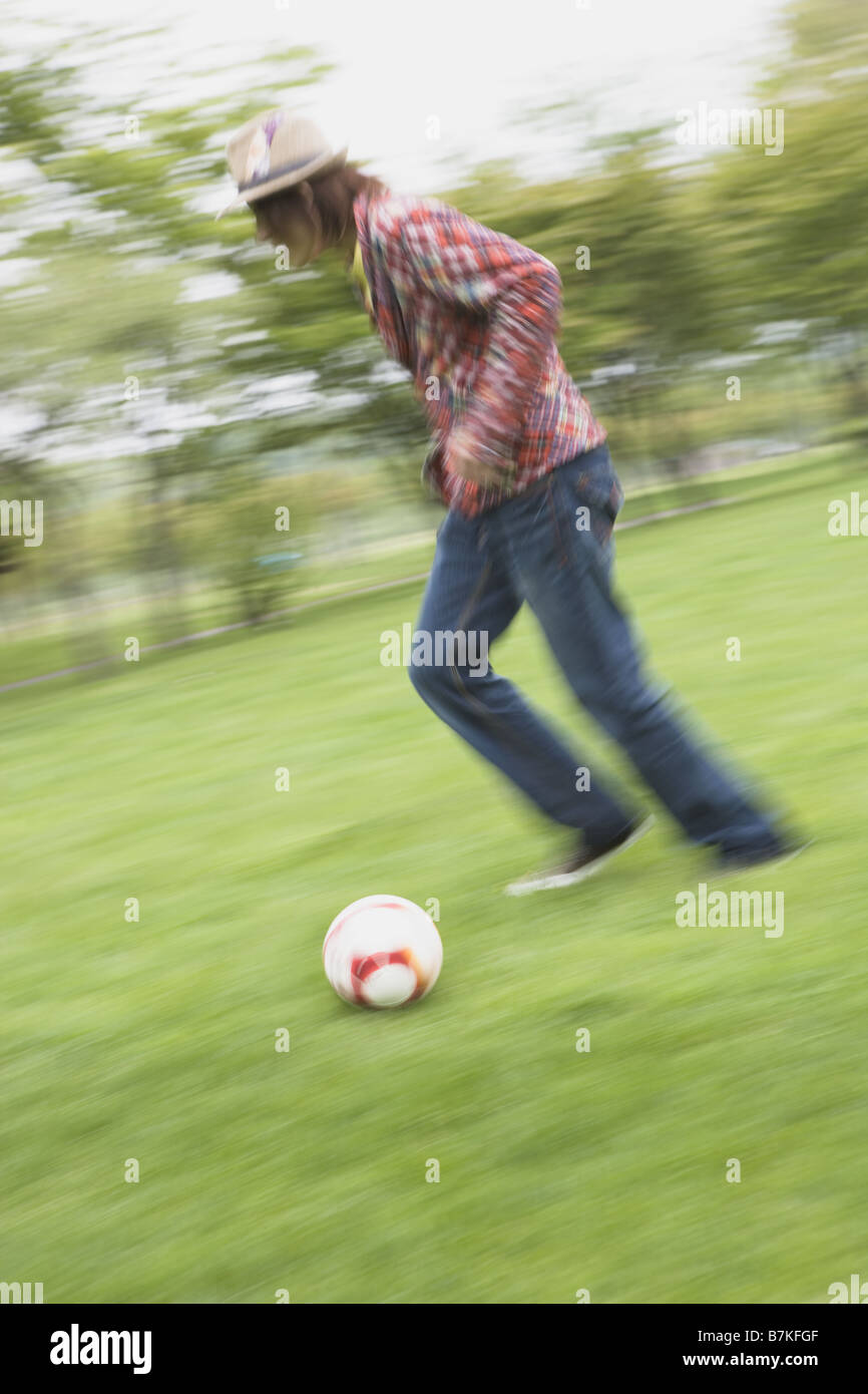 Young Man Kicking Ball Stock Photo Alamy