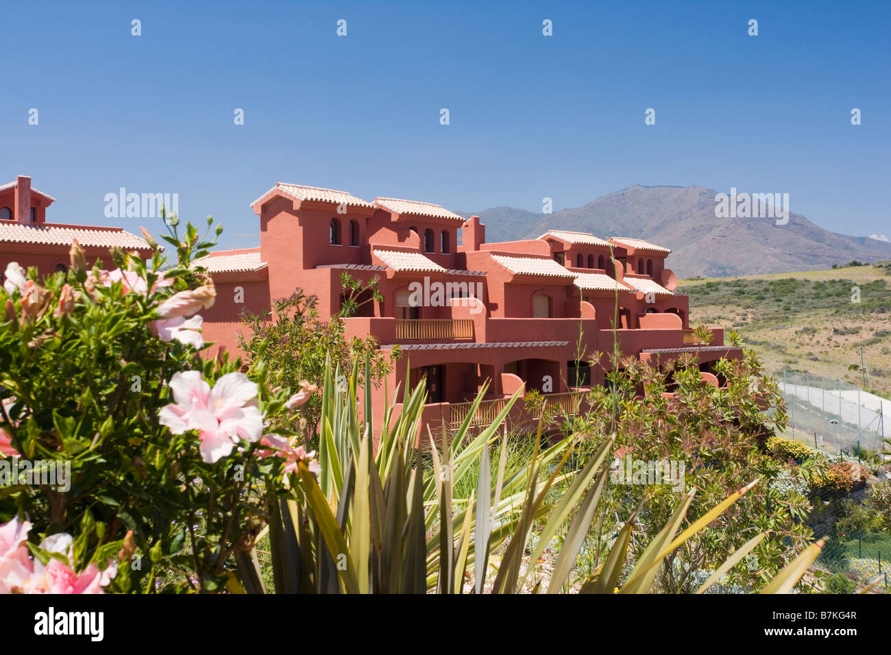 New terracotta coloured villas and apartments on hillside site for sale