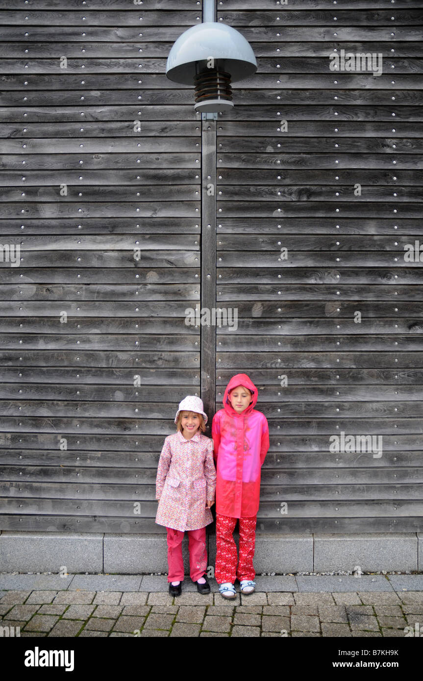 Two sisters shelter as the rain begins to fall Stock Photo