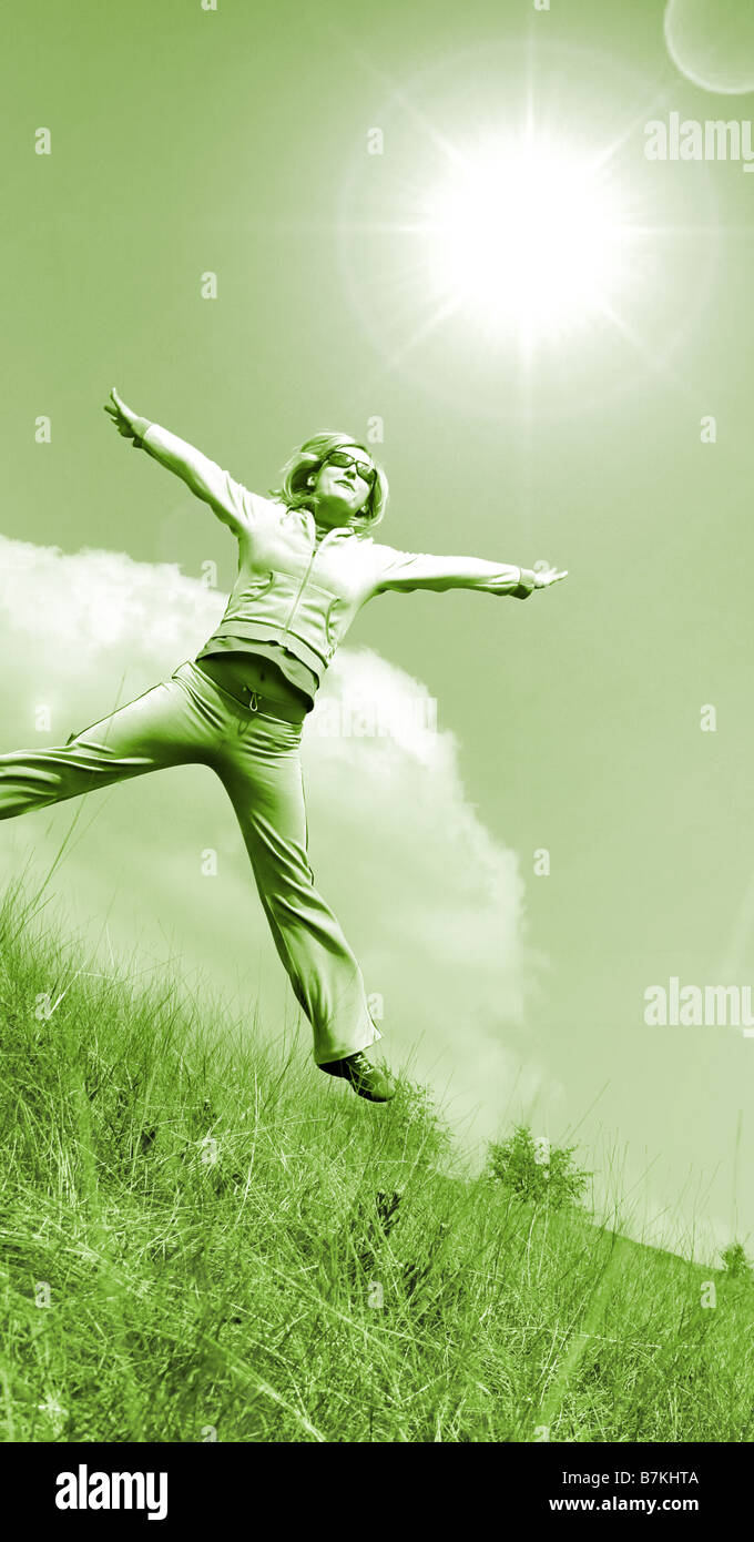 Happy woman jumping against blue sky Stock Photo - Alamy