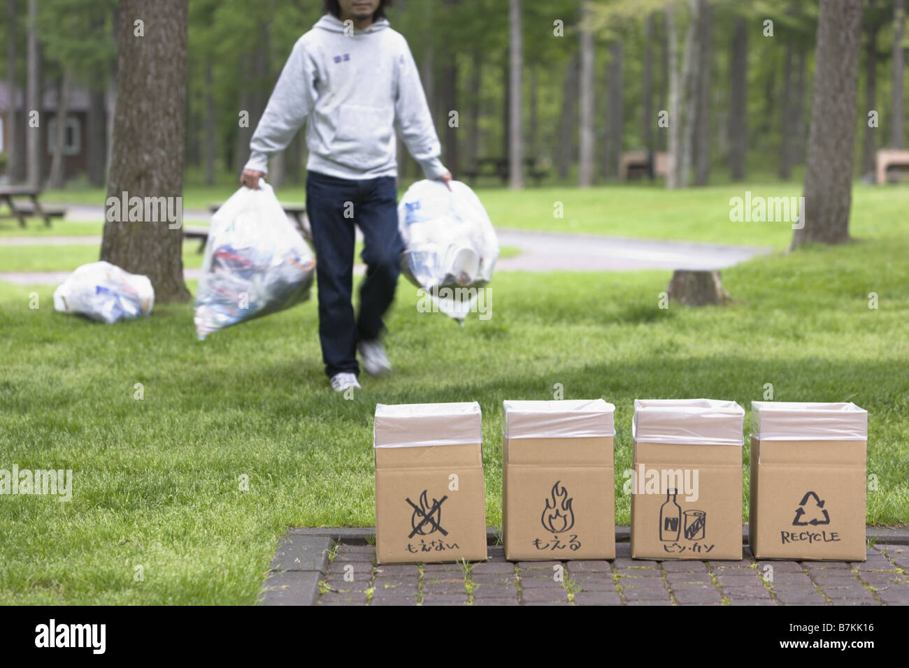 Man with Trash Bag Walking Stock Photo - Alamy